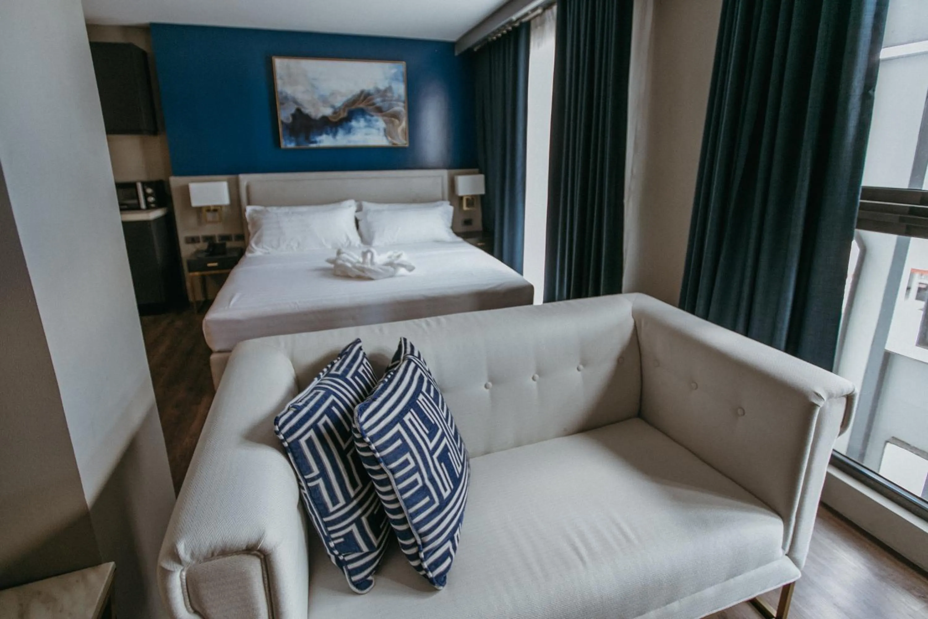 Living room, Bed in PVL Suites