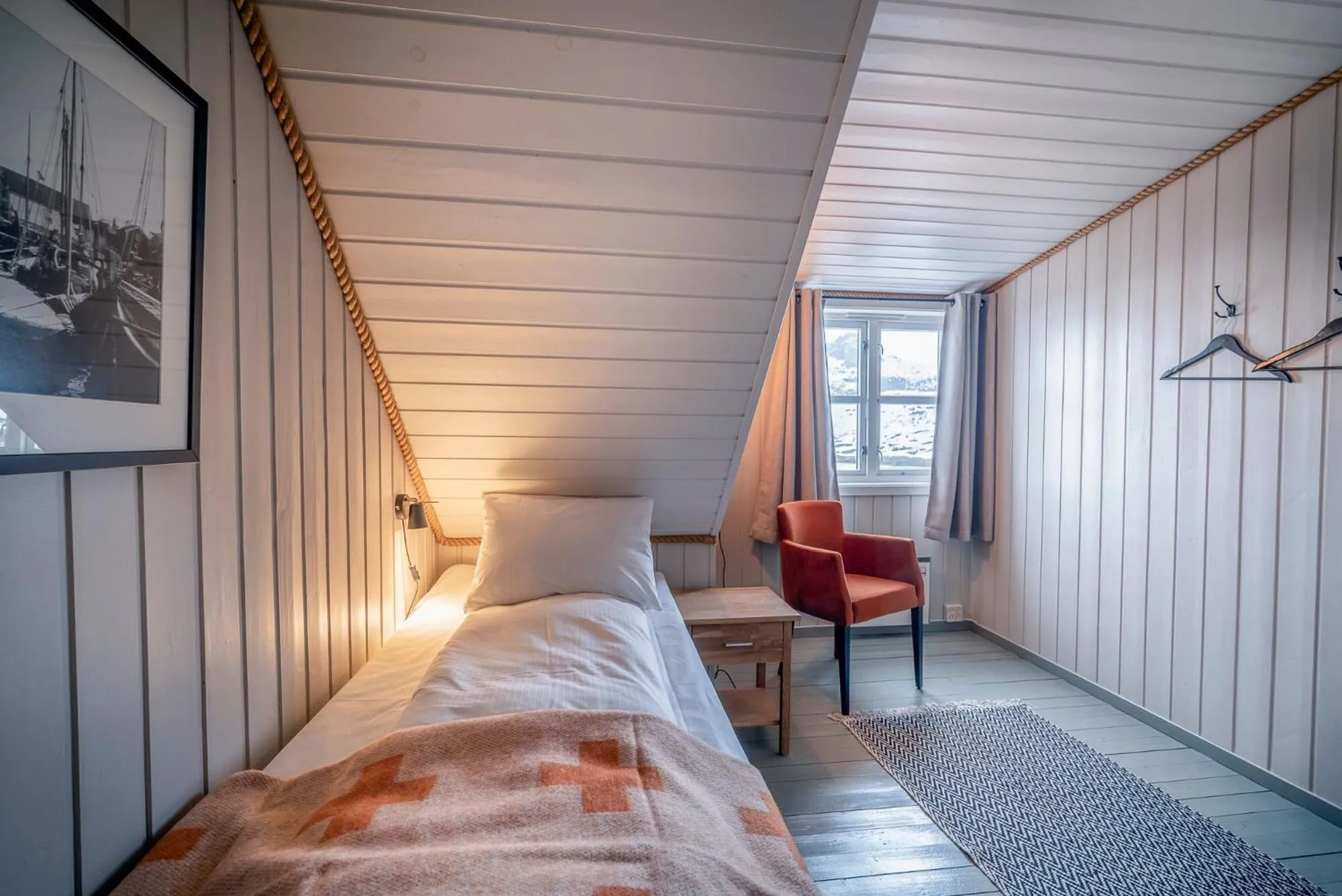 Bed in Nyvågar Rorbuhotell - by Classic Norway Hotels