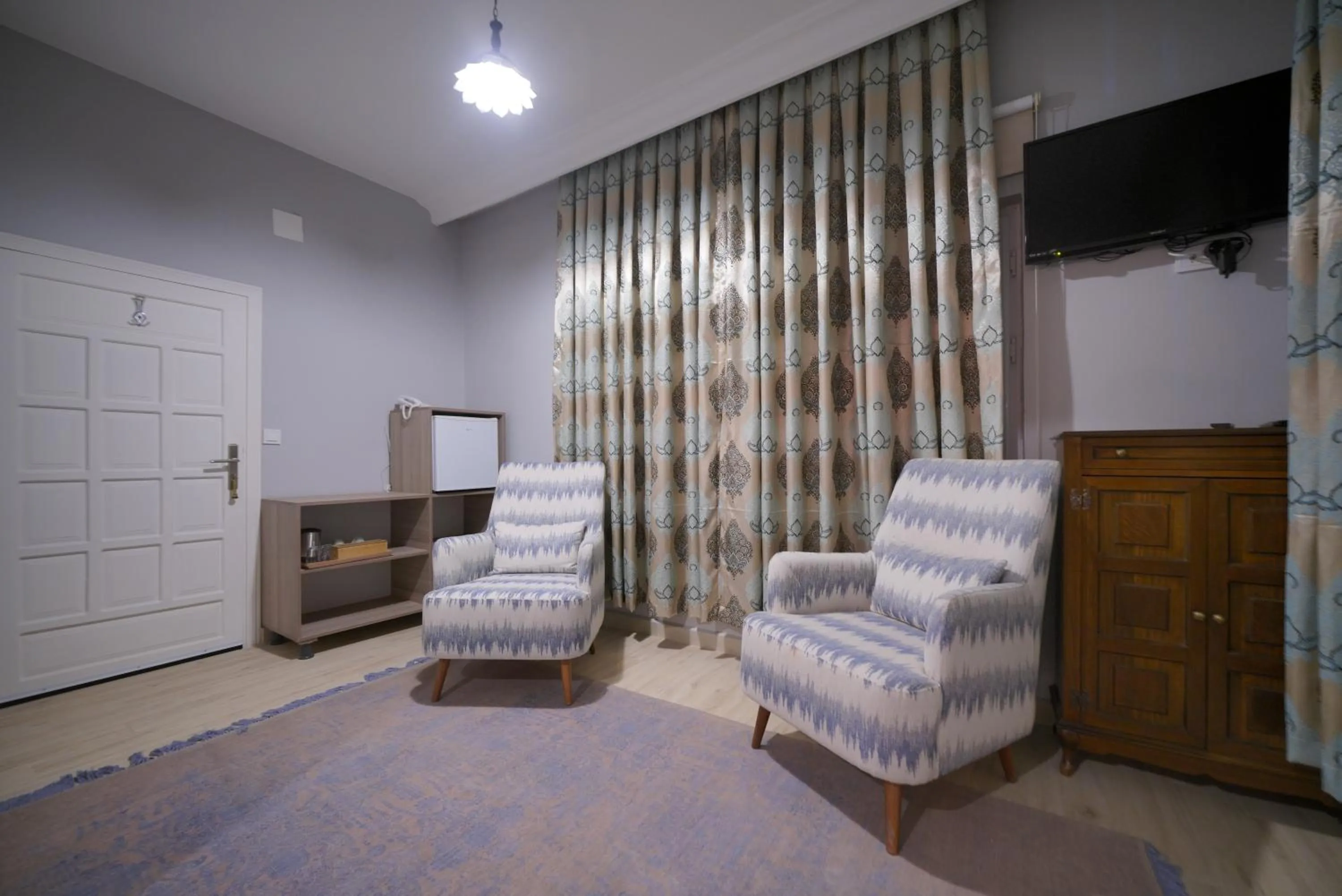 Communal lounge/ TV room in Pashabelle Hotel