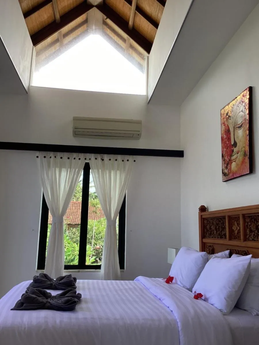 Bed in Puri Oka Beach Bungalows