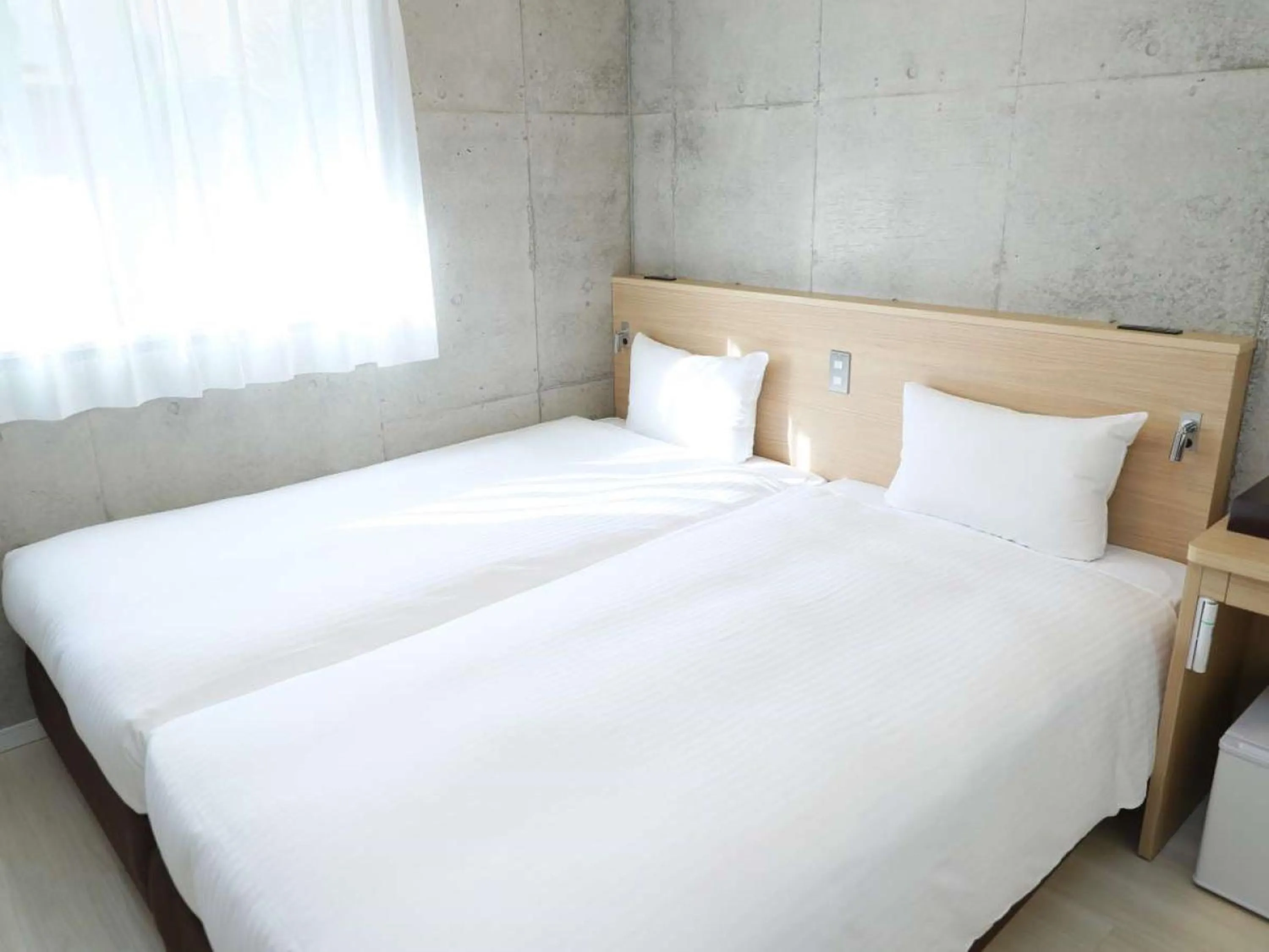 Bed in The BREAKFAST HOTEL MARCHE Ishigaki Island