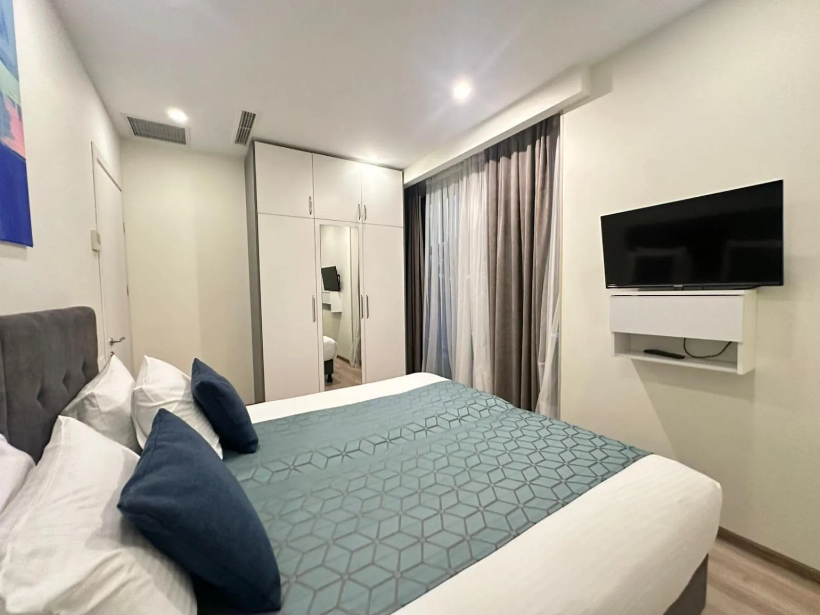 Bed in Bellevue Residence Suites