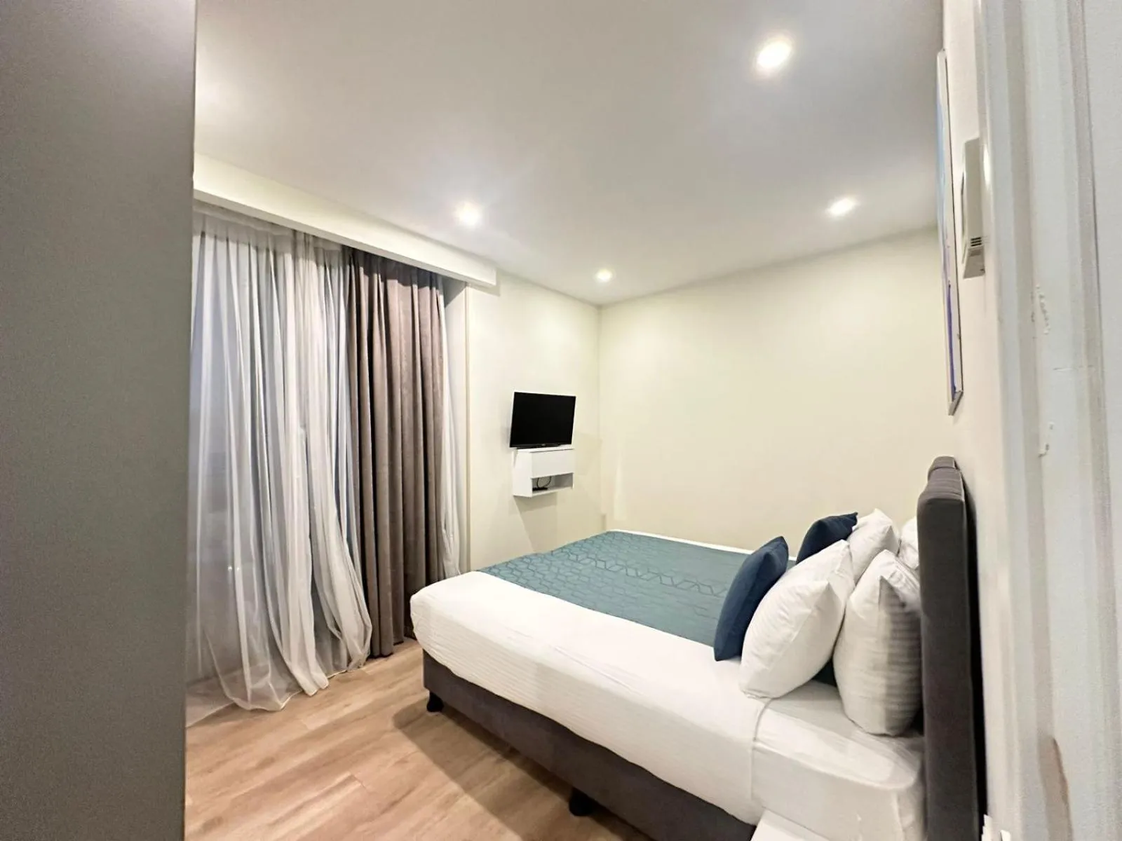 Bed in Bellevue Residence Suites