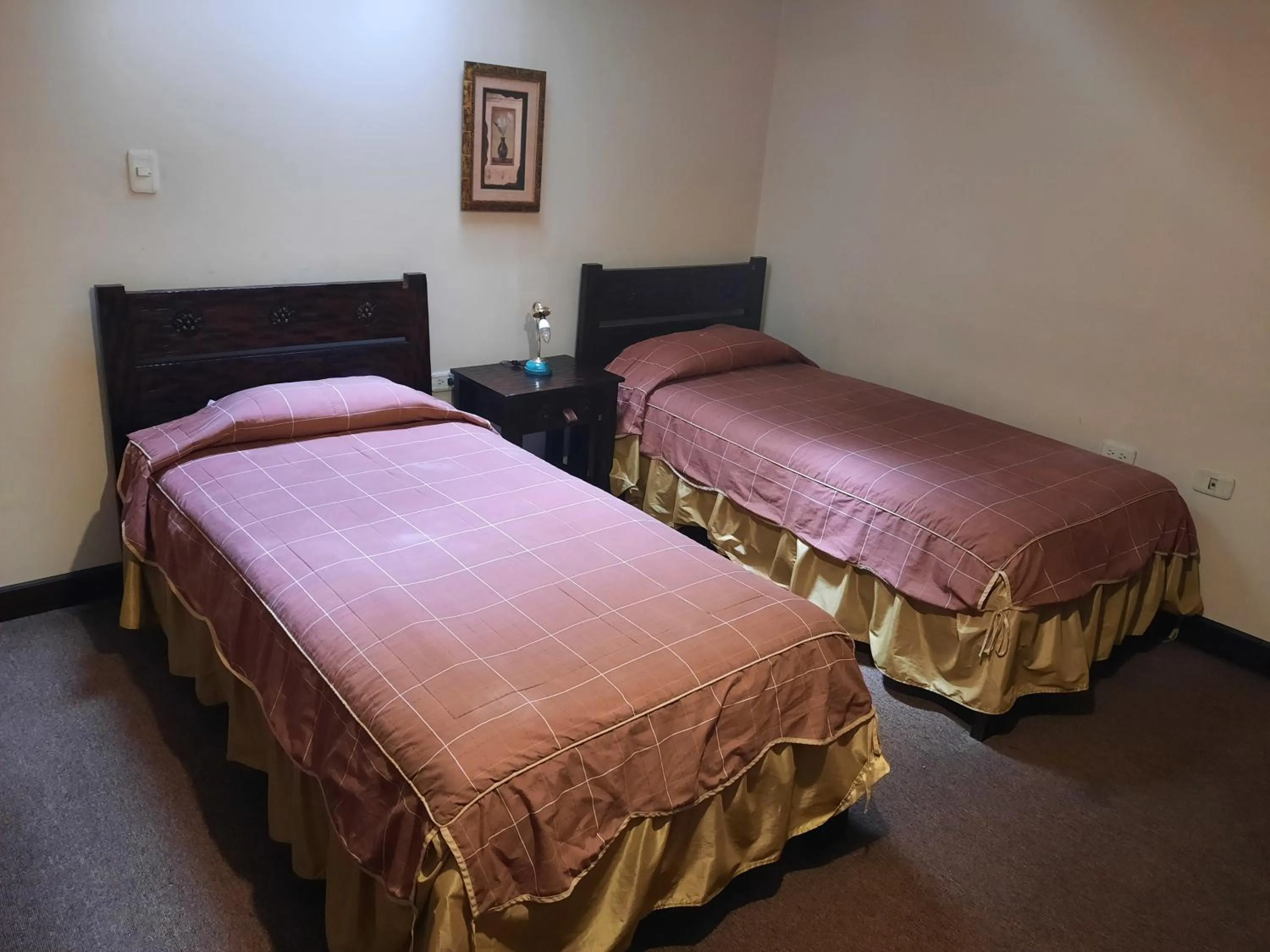 Bed in La Posada Cuencana Hotel