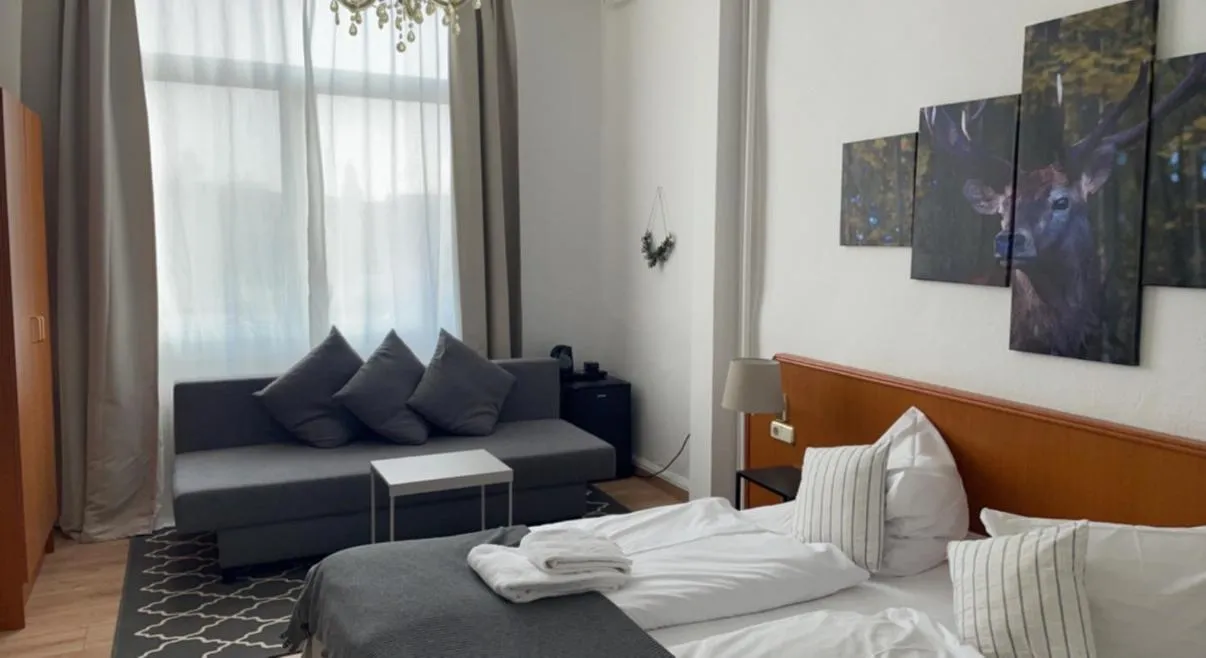 Seating area, Bed in Berghotel HARZ