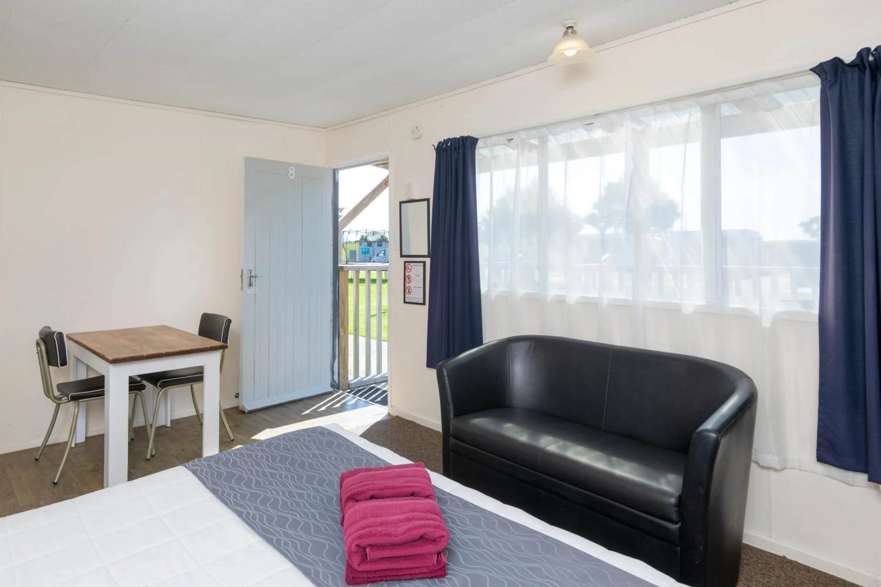 Seating area, Bed in Riverside Whakatane Holiday Park