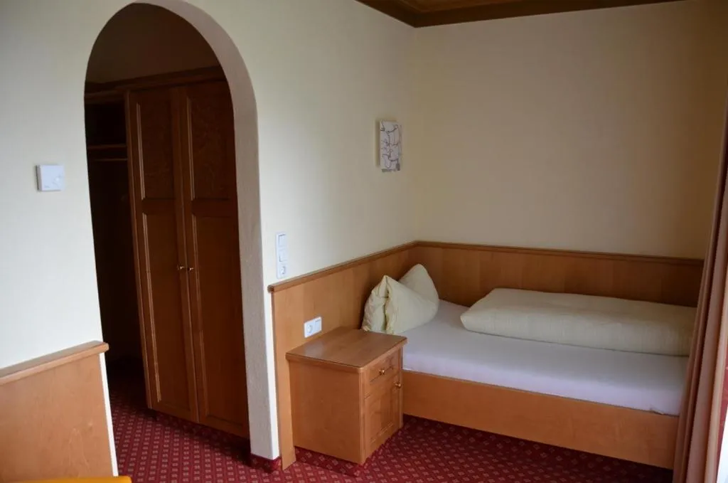 Bed in Hotel-Pension Strolz