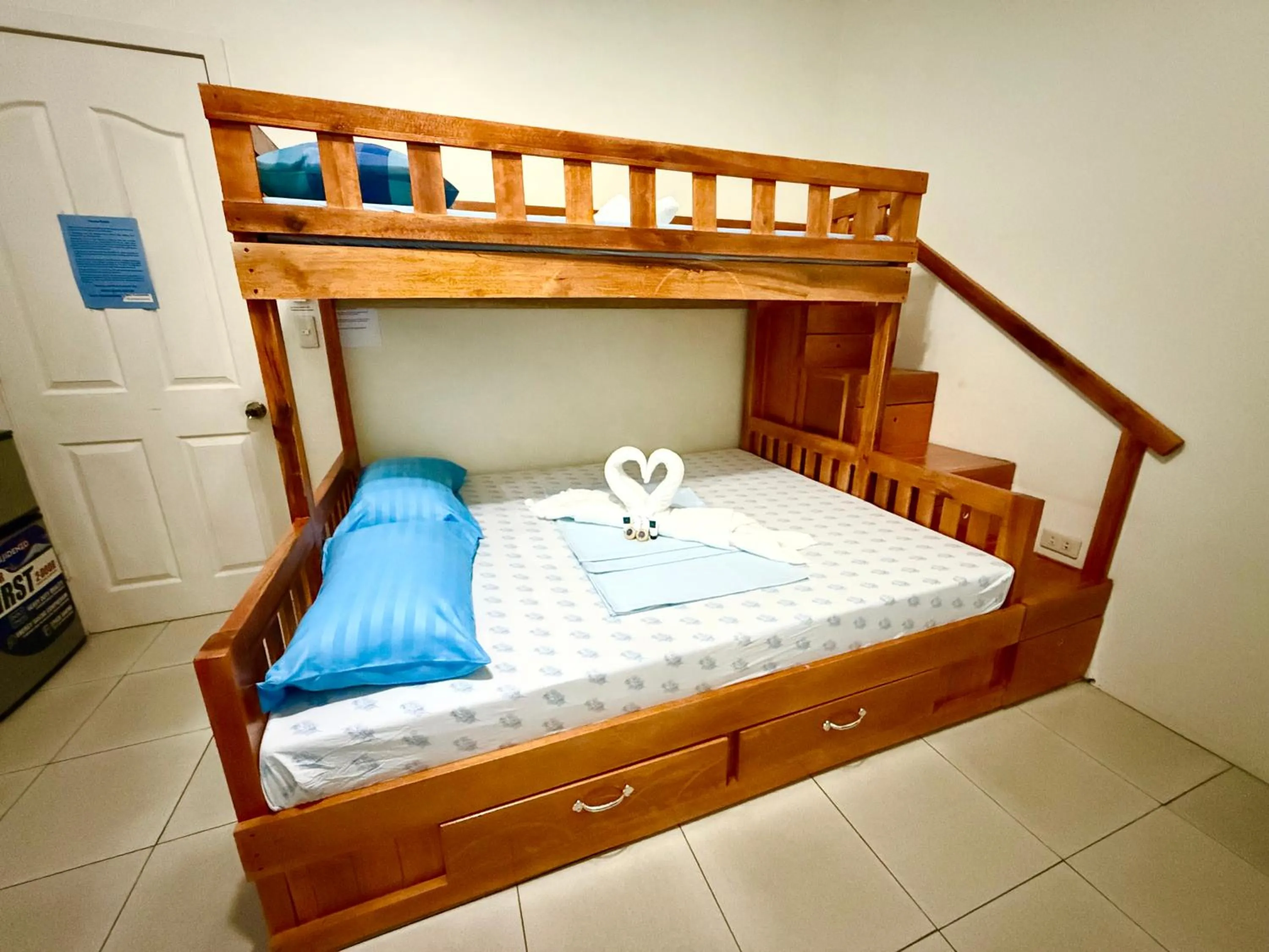 Bed in Blue Summer Suites & Restaurant