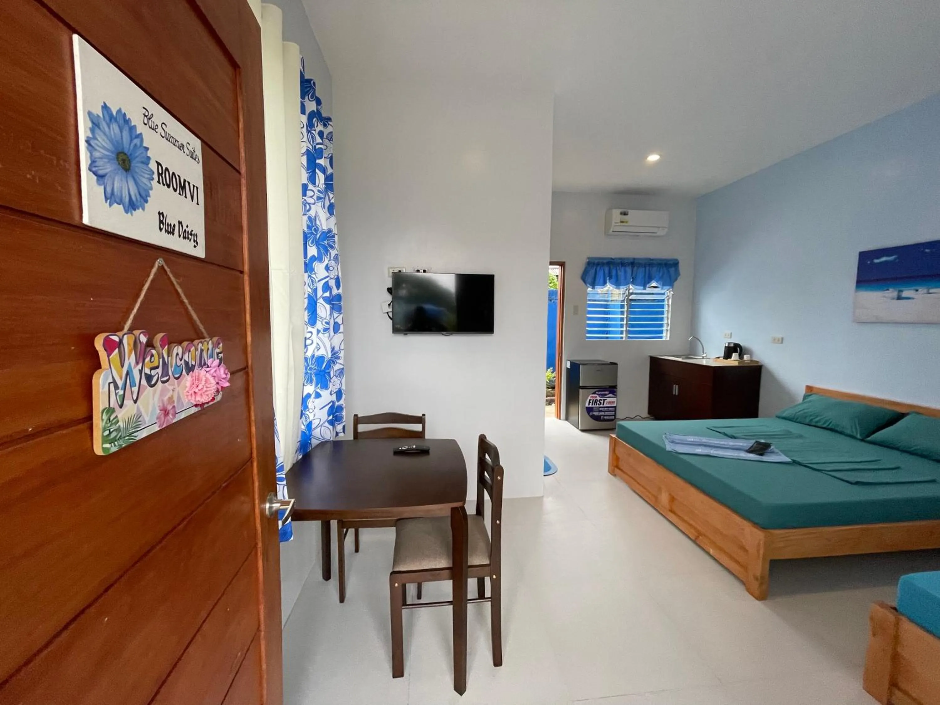 Bed in Blue Summer Suites & Restaurant