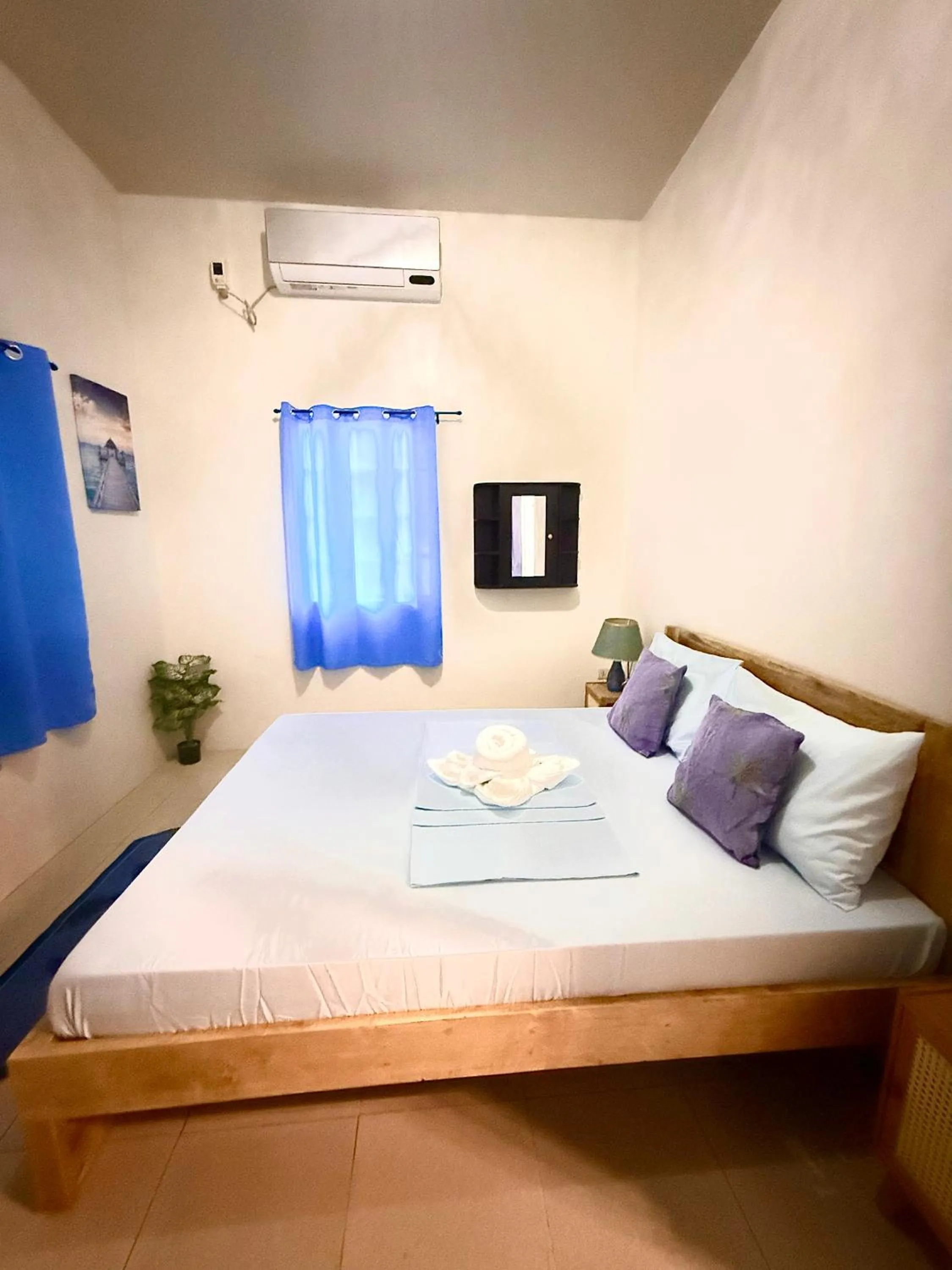 Bed in Blue Summer Suites & Restaurant