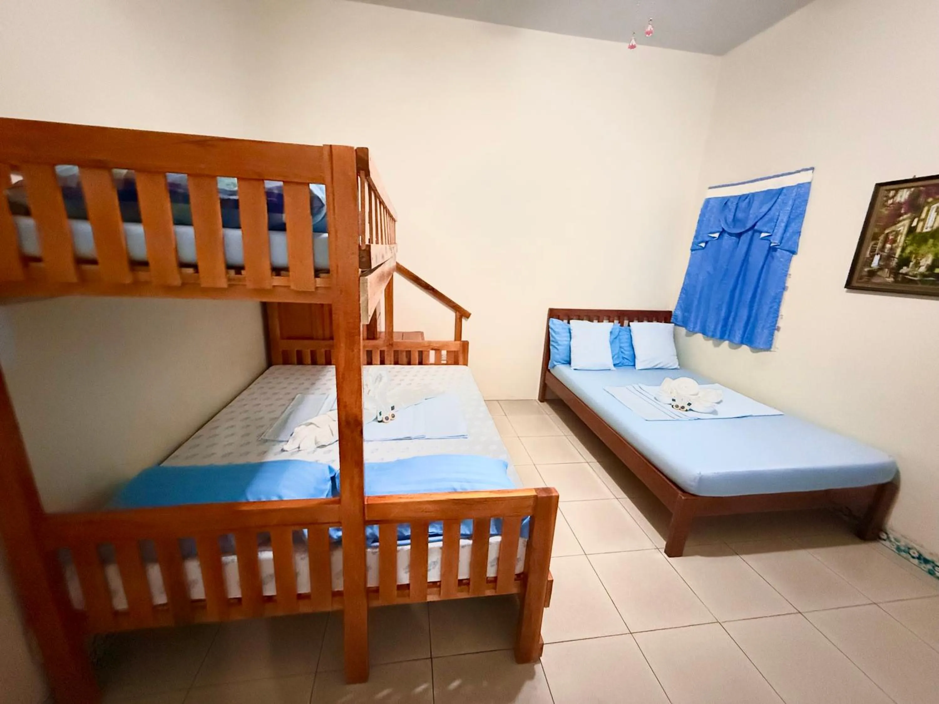 Bed in Blue Summer Suites & Restaurant