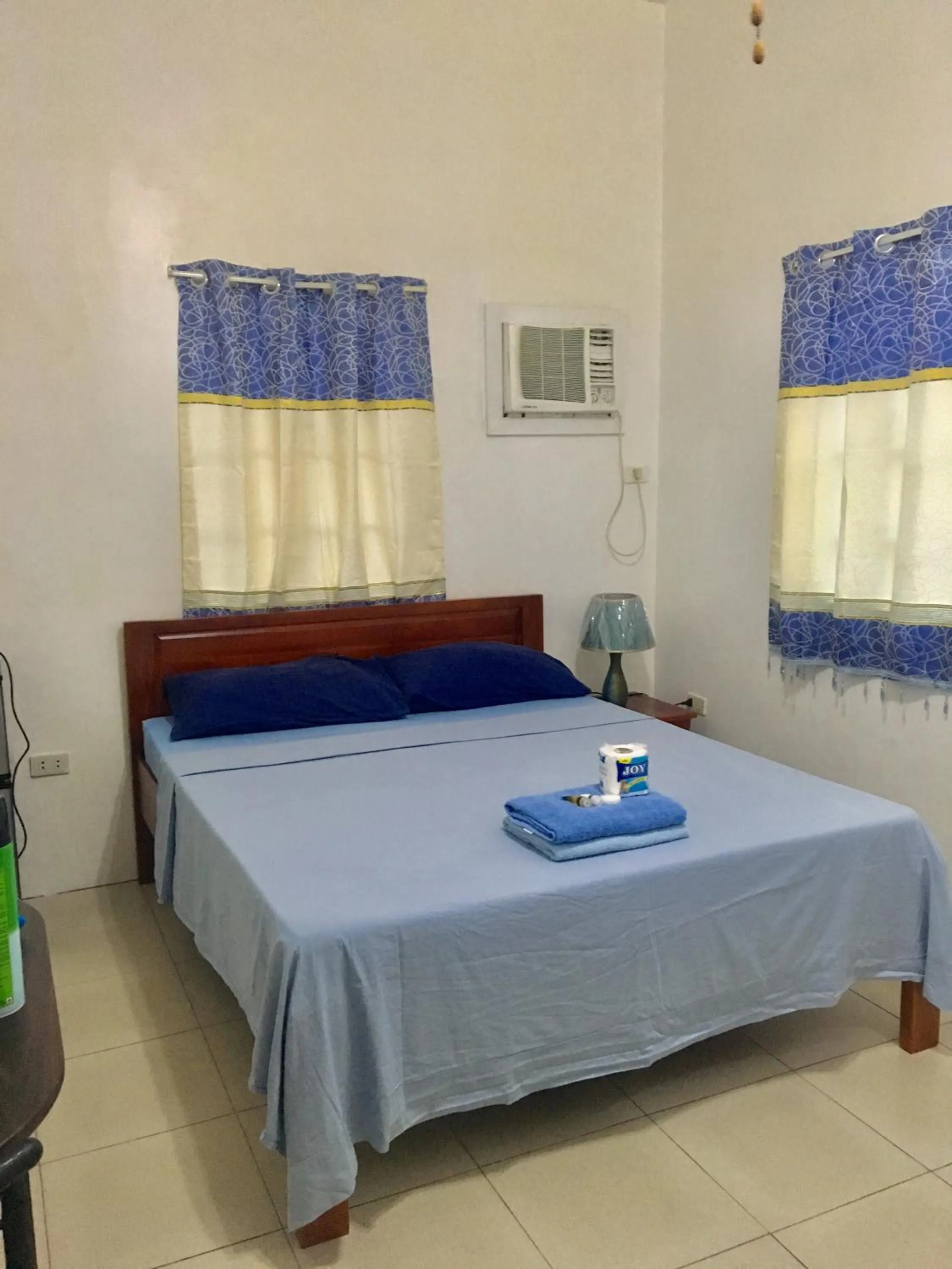 Bed in Blue Summer Suites & Restaurant