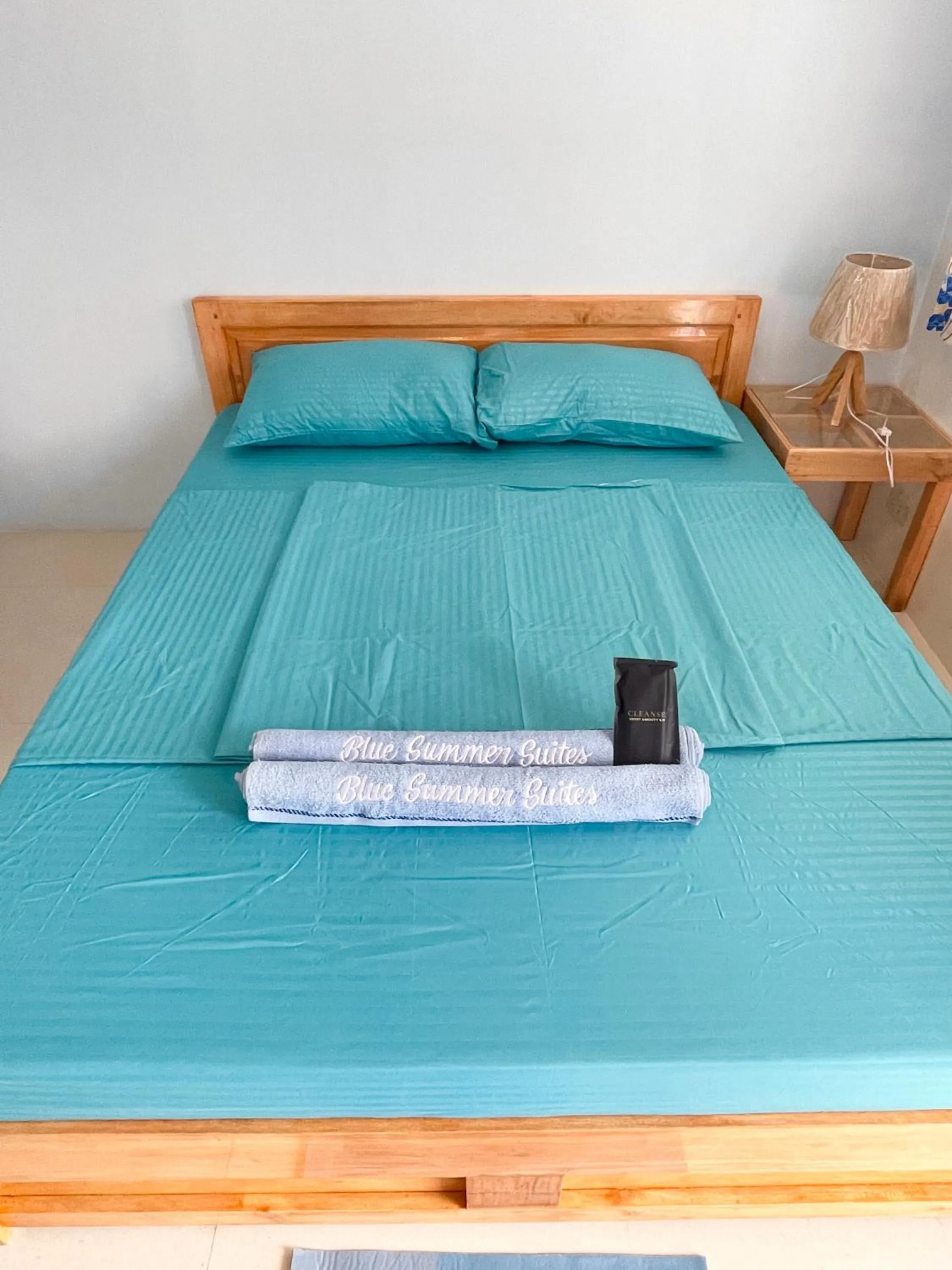 Bed in Blue Summer Suites & Restaurant