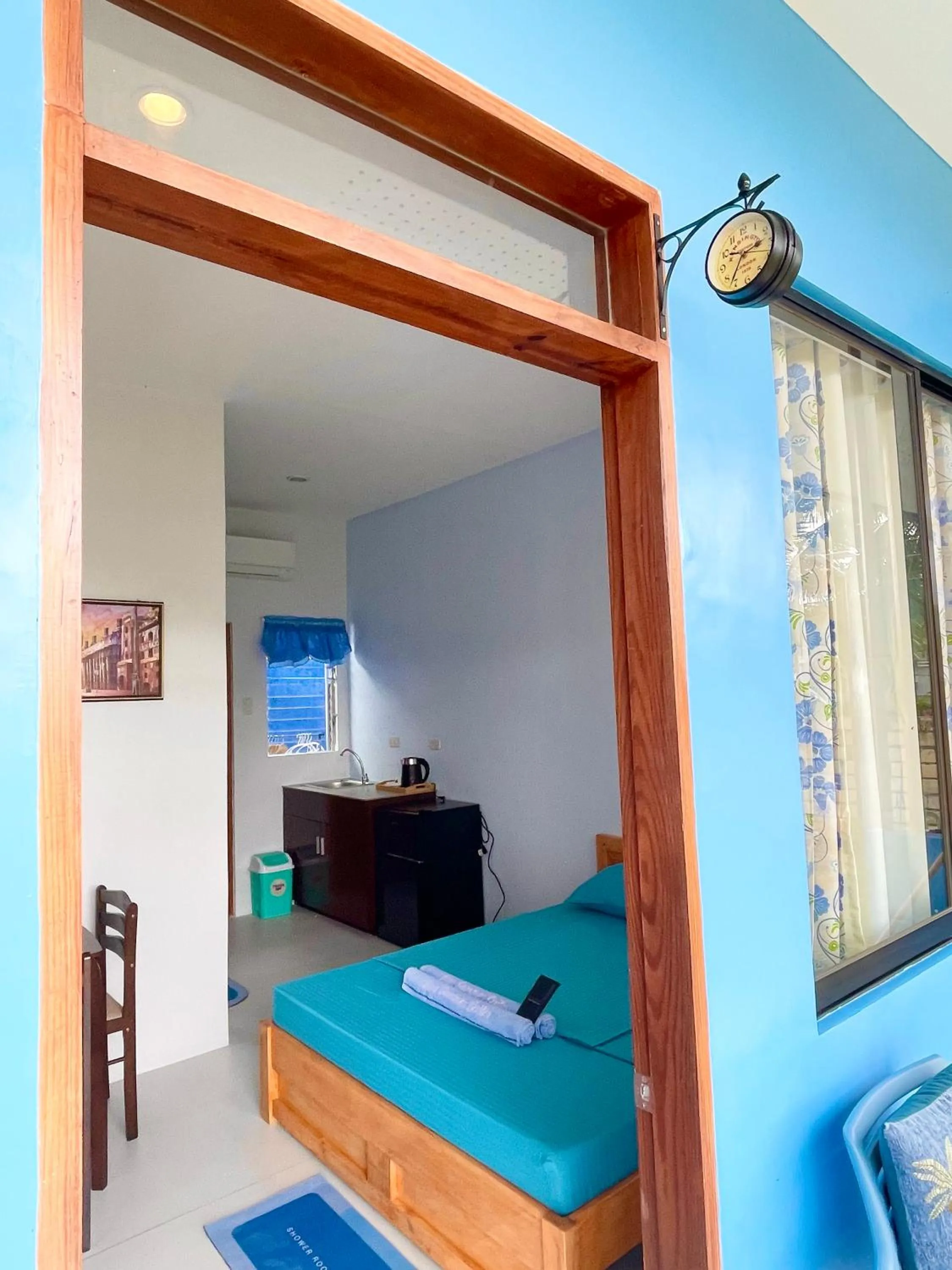 Bed in Blue Summer Suites & Restaurant