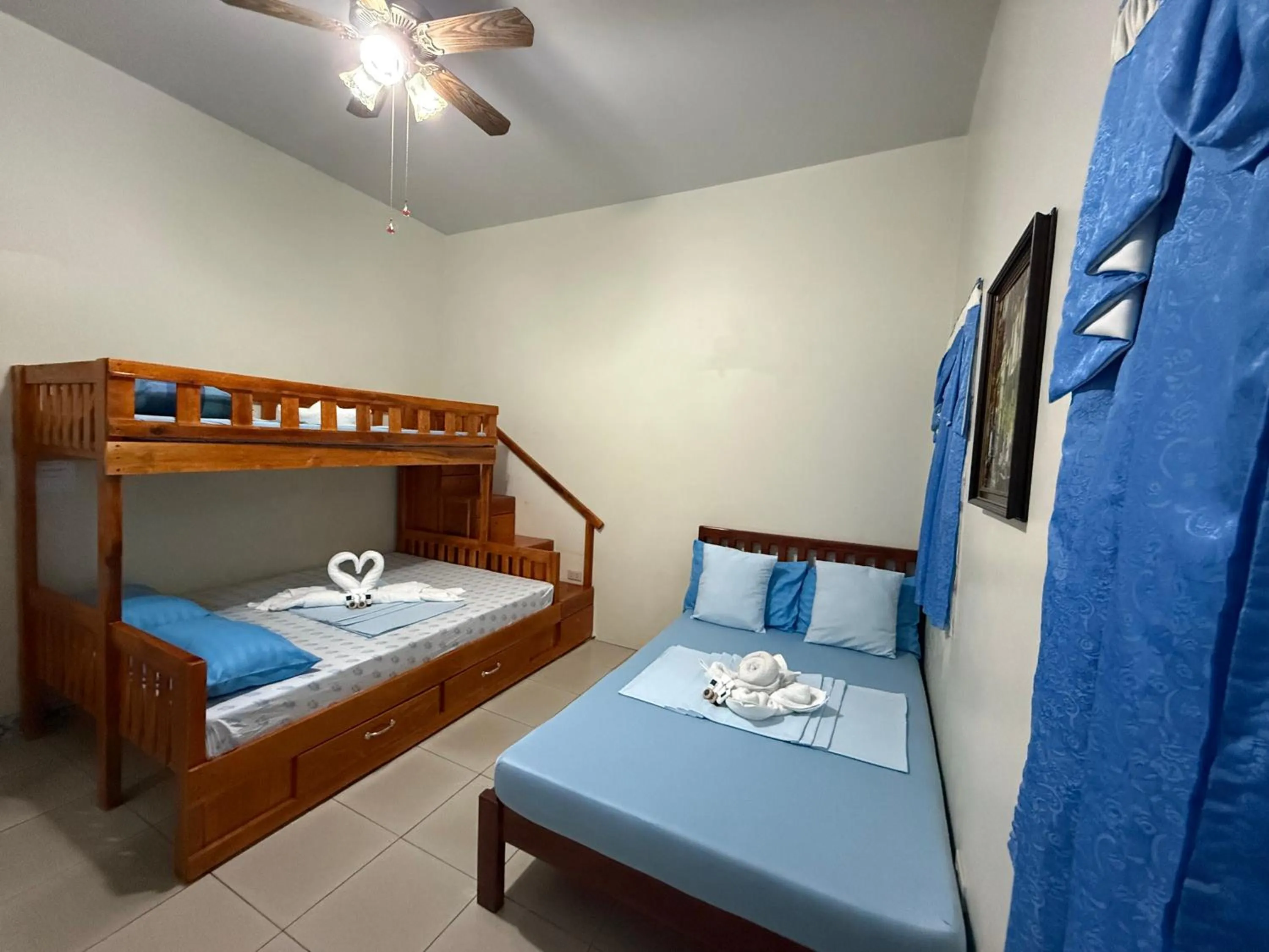 Bed in Blue Summer Suites & Restaurant