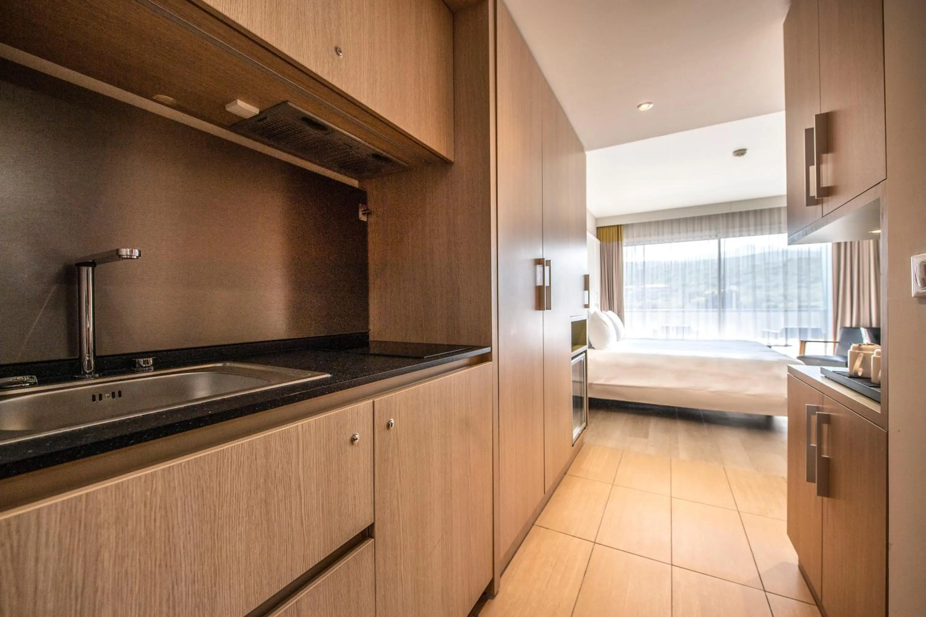 Kitchen or kitchenette, Bed in Radisson Blu Resort & Spa, Ajaccio Bay