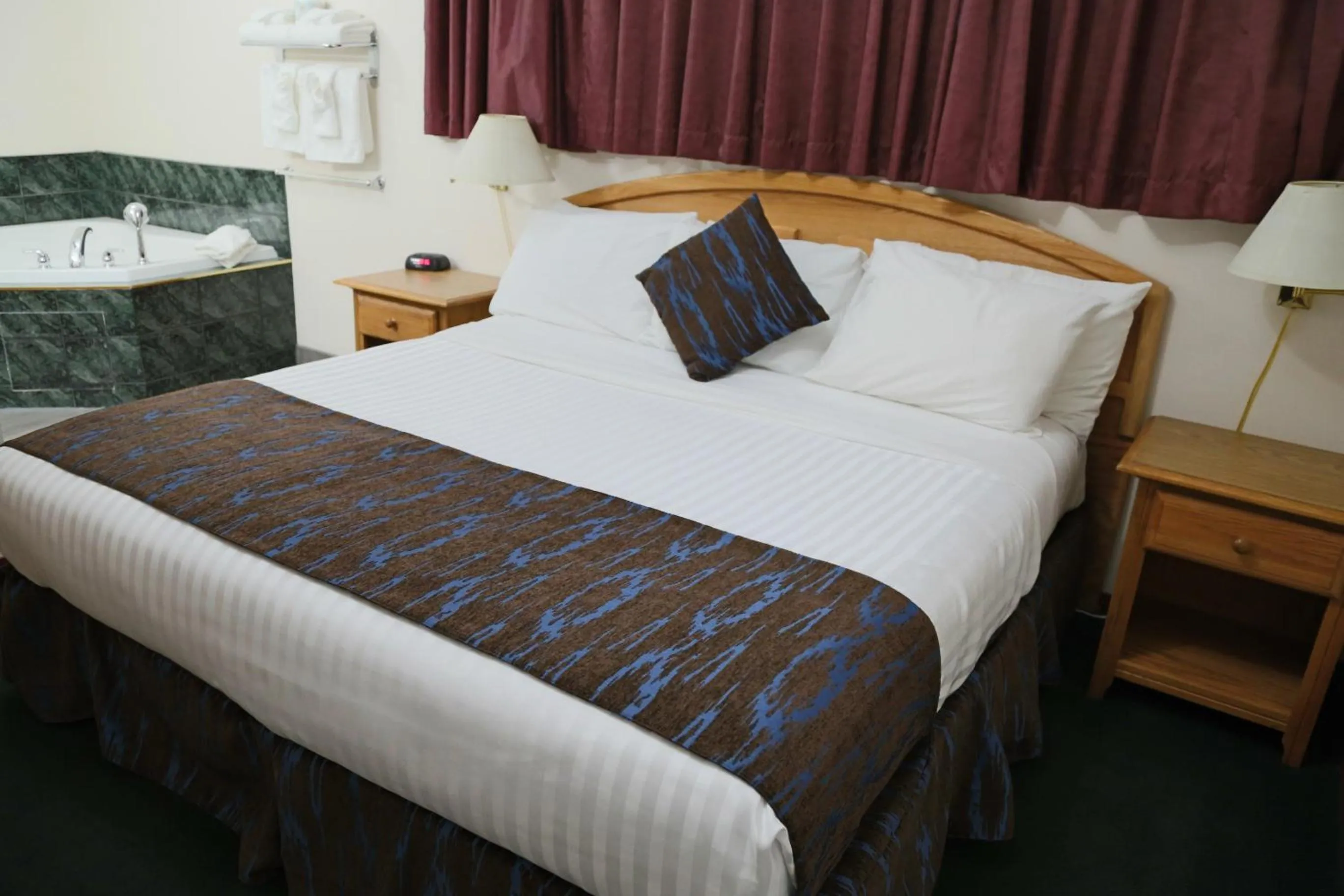 Bed in SlumberLodge Hotel