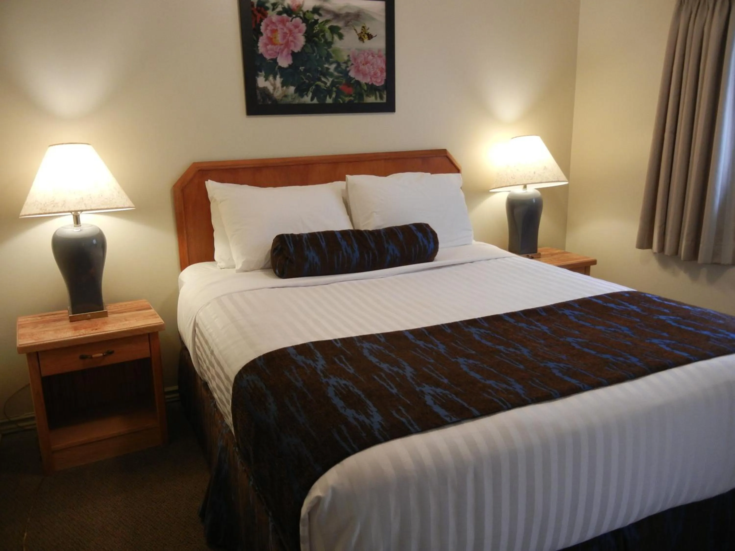 Bed in SlumberLodge Hotel