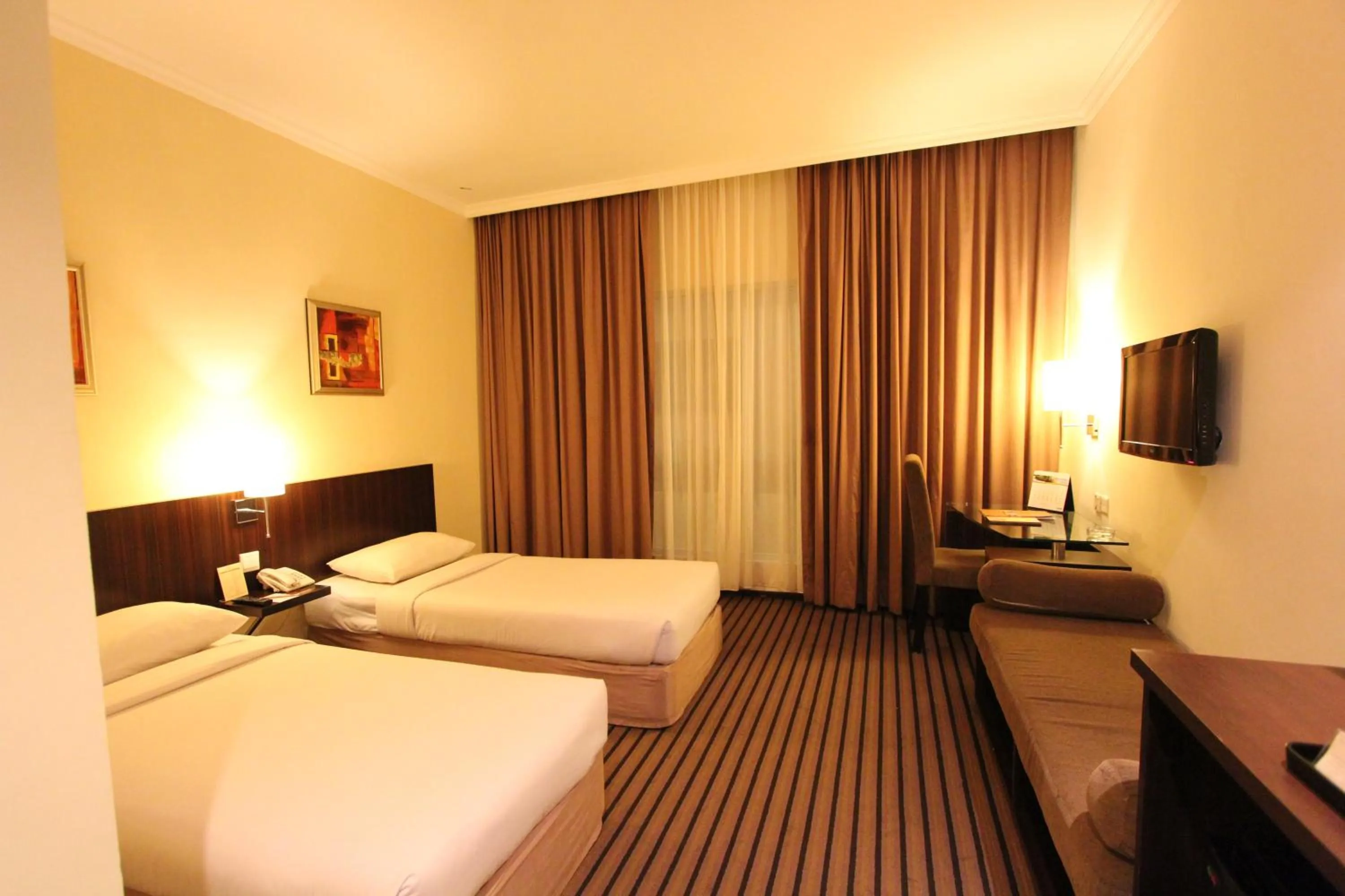 Bed in Harmoni One Convention Hotel and Service Apartments