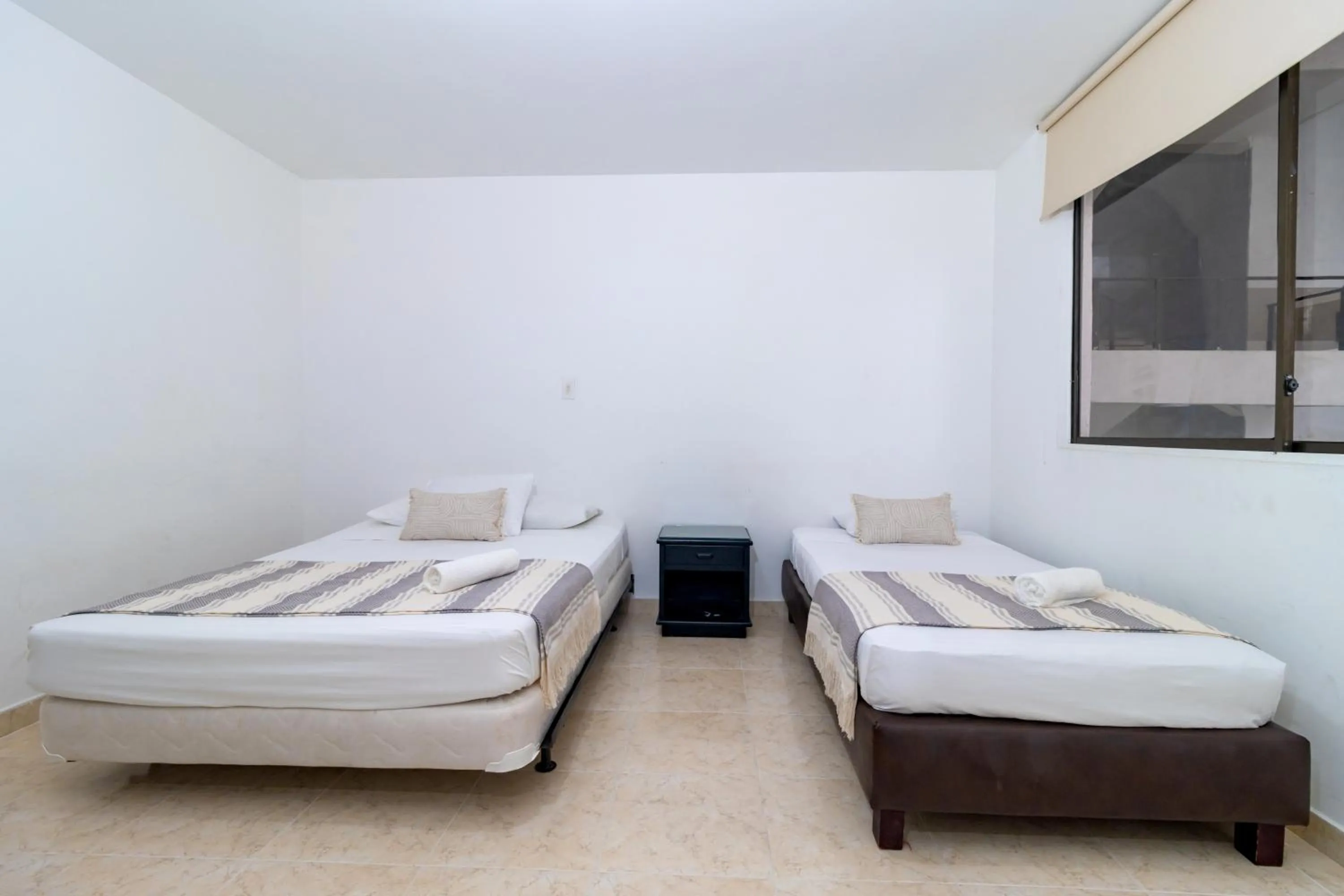 Bed in Hotel Axis Inn By GEH Suites