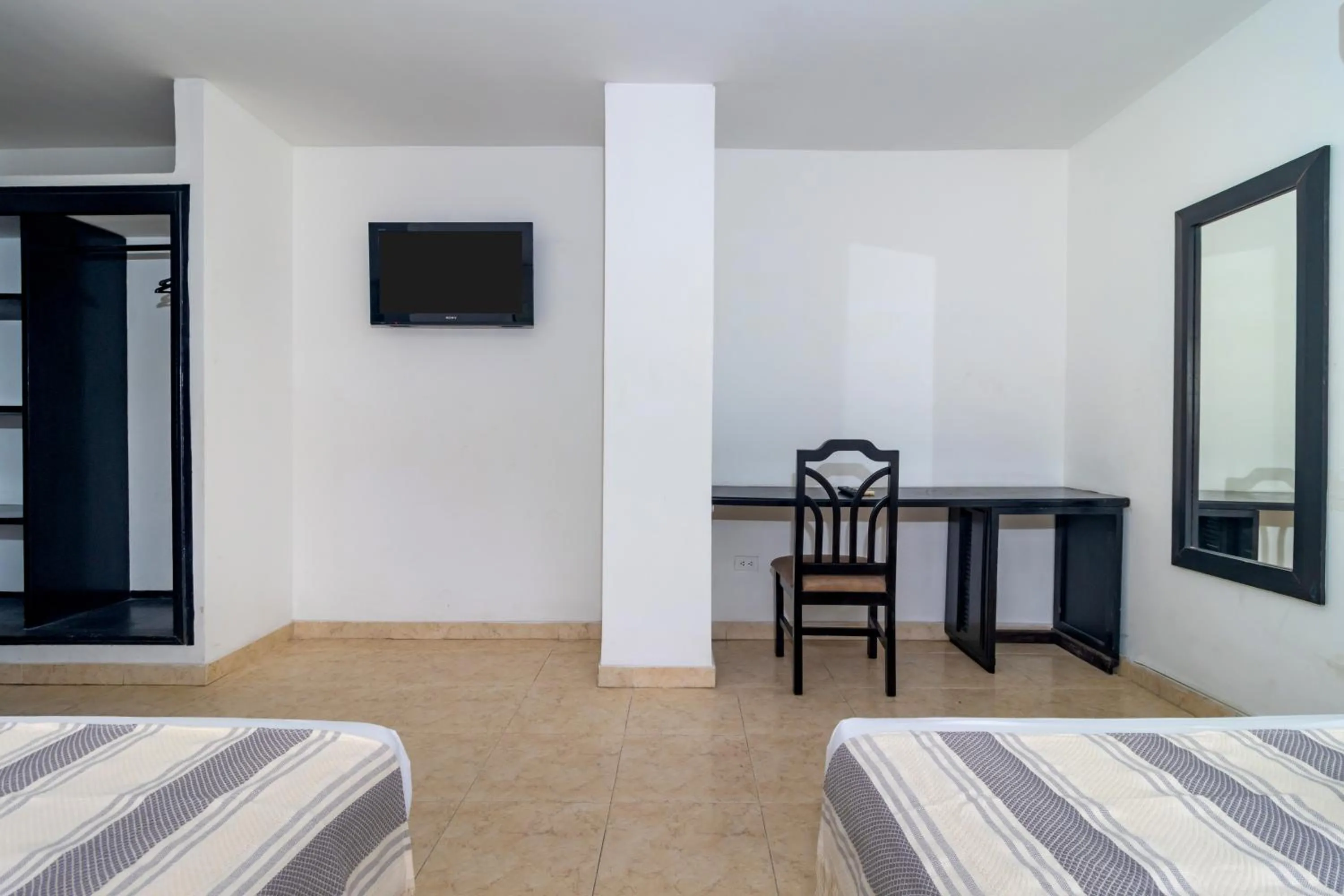 Bed in Hotel Axis Inn By GEH Suites