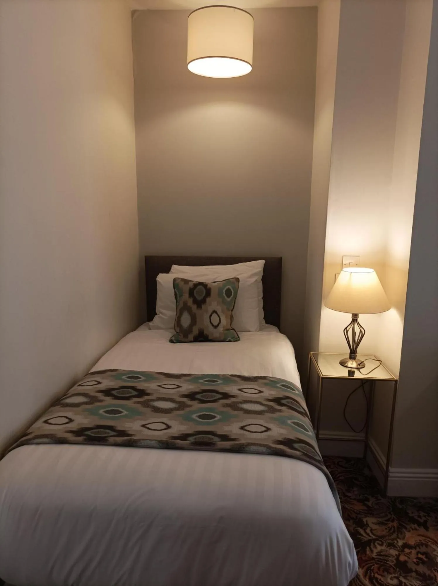 Bed in Tom Dick and Harriet's Accommodation