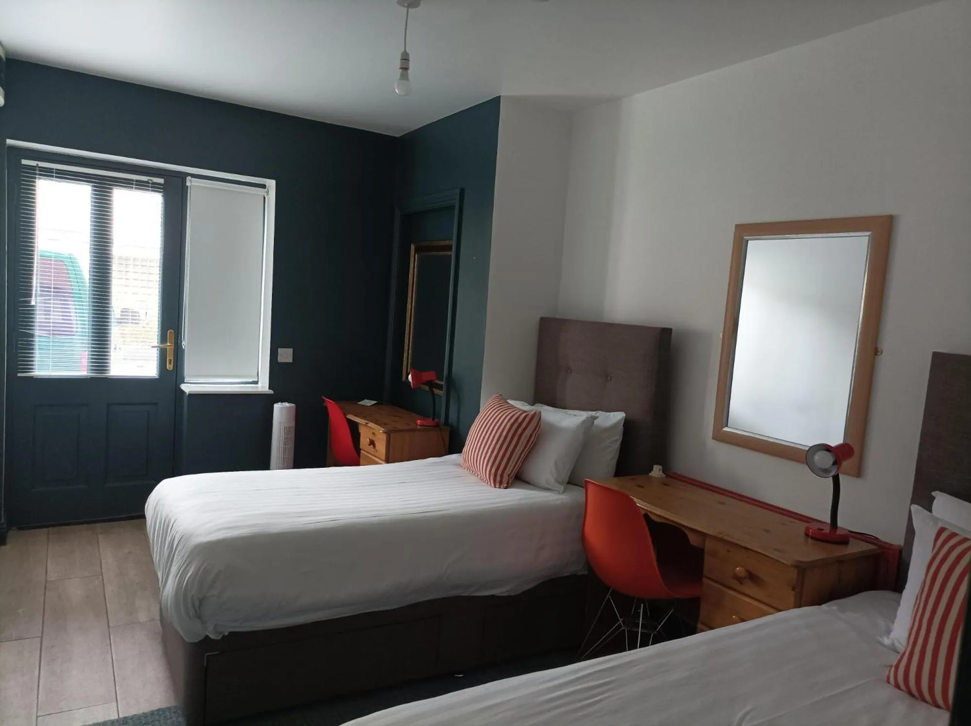 Bed in Tom Dick and Harriet's Accommodation