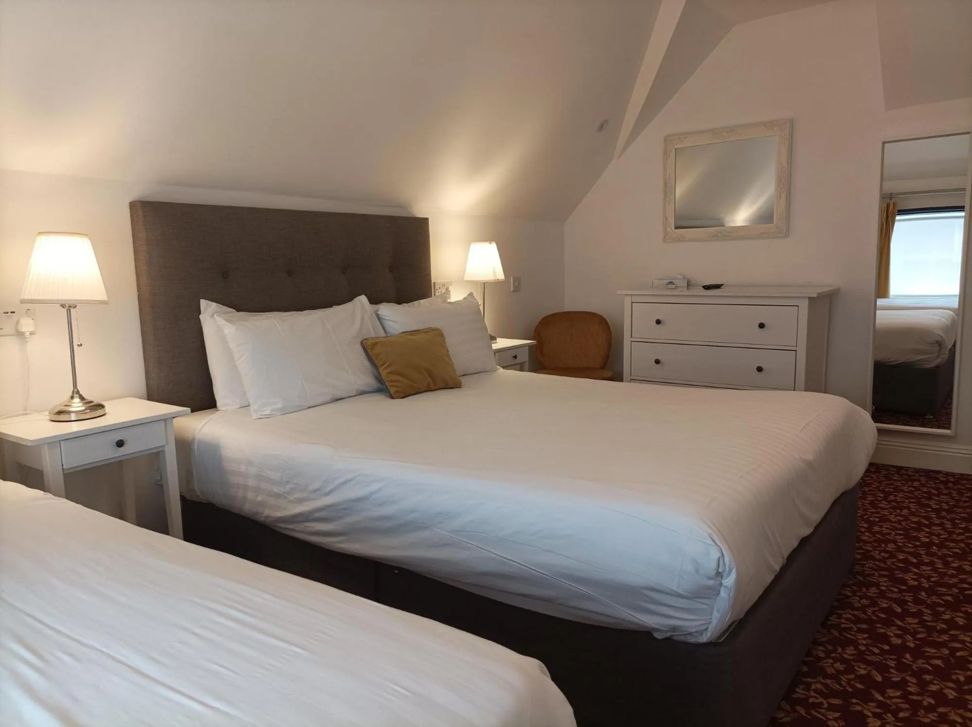 Bed in Tom Dick and Harriet's Accommodation