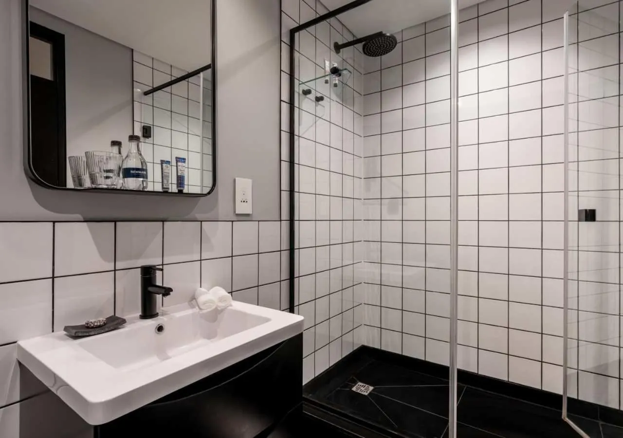 Shower in The Onyx Apartment Hotel by NEWMARK