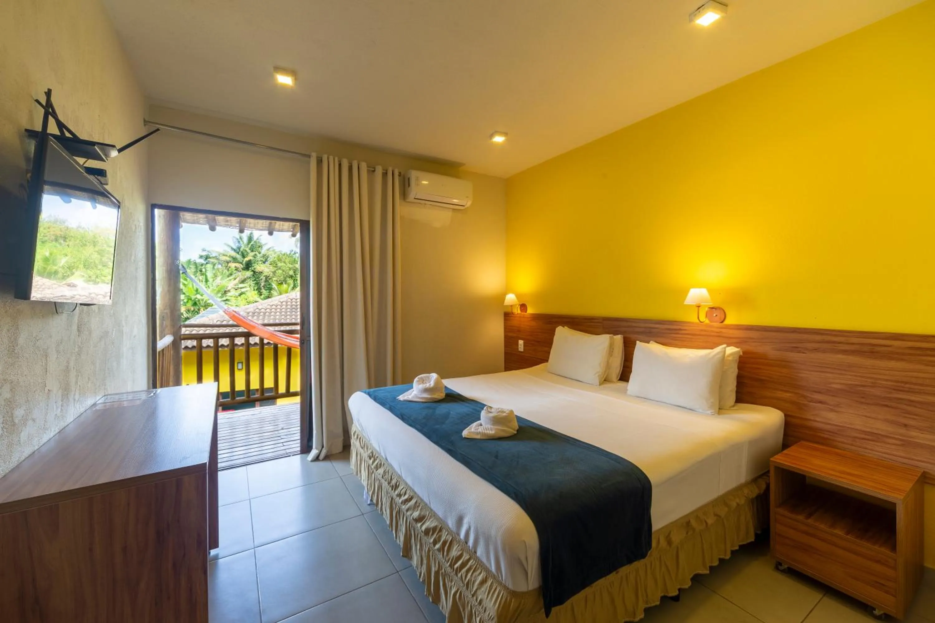 Bed in Pousada Tropicarim