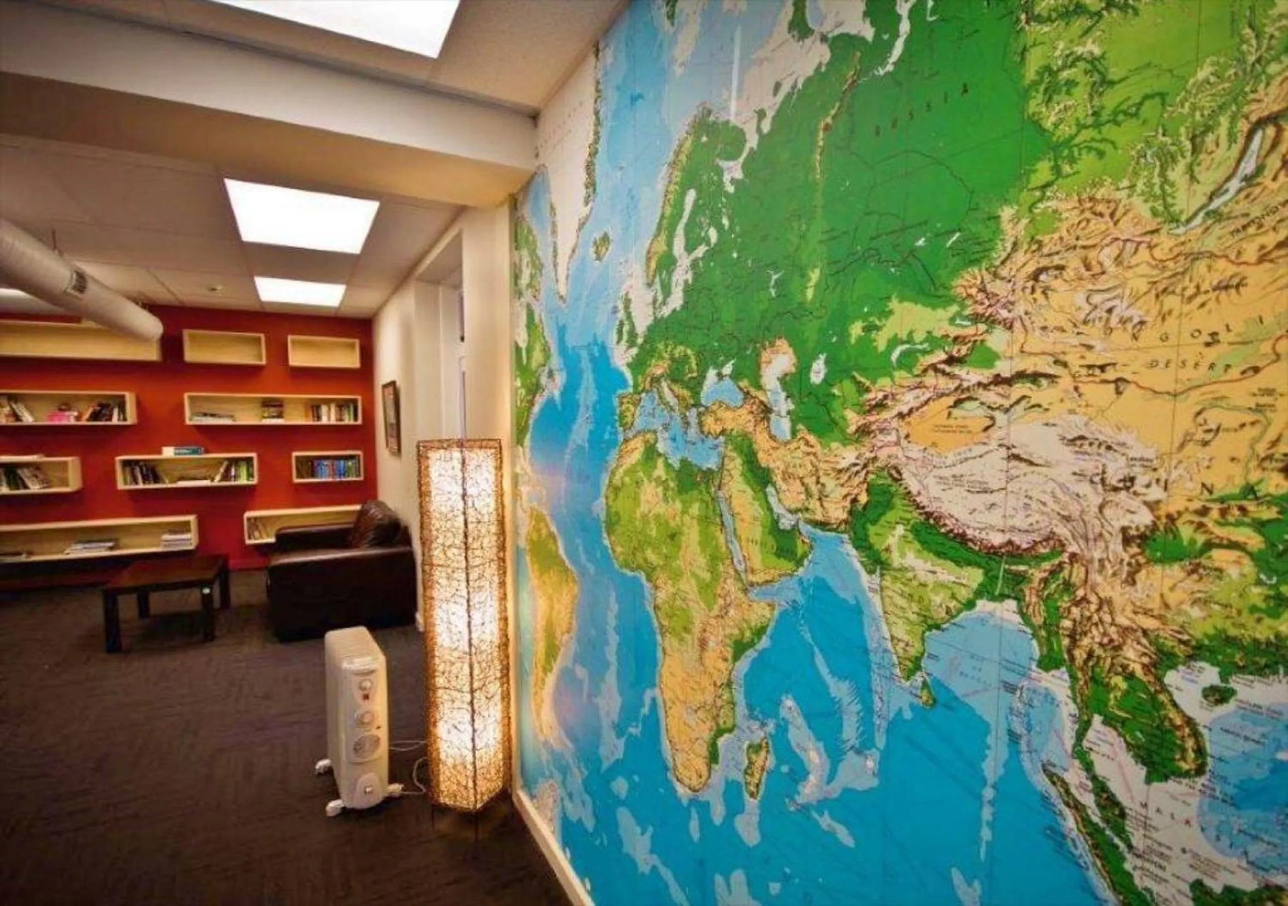 Communal lounge/ TV room in Trek Global Backpackers