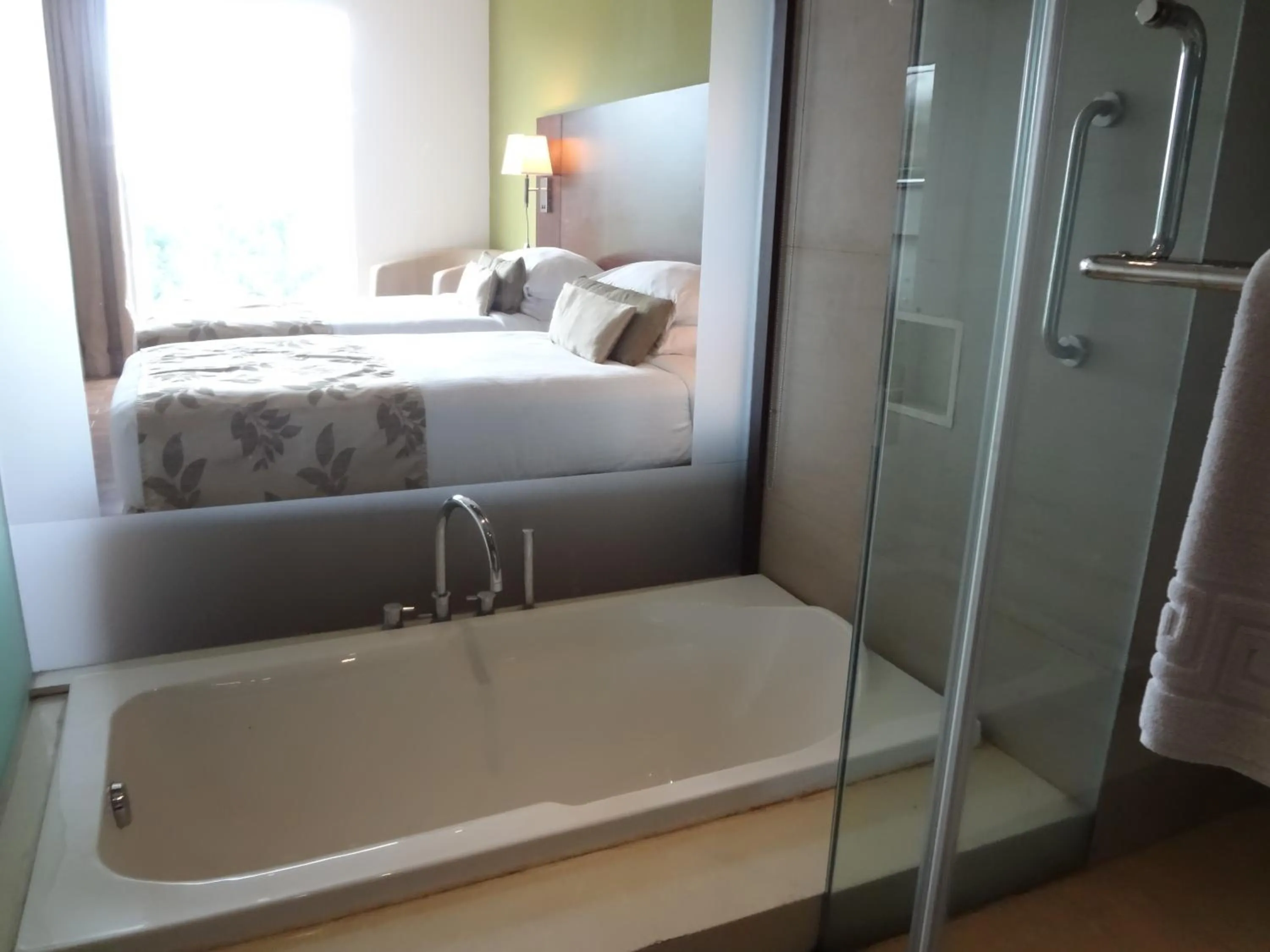 Bathroom, Bed in Ramee Grand Hotel and Spa, Pune