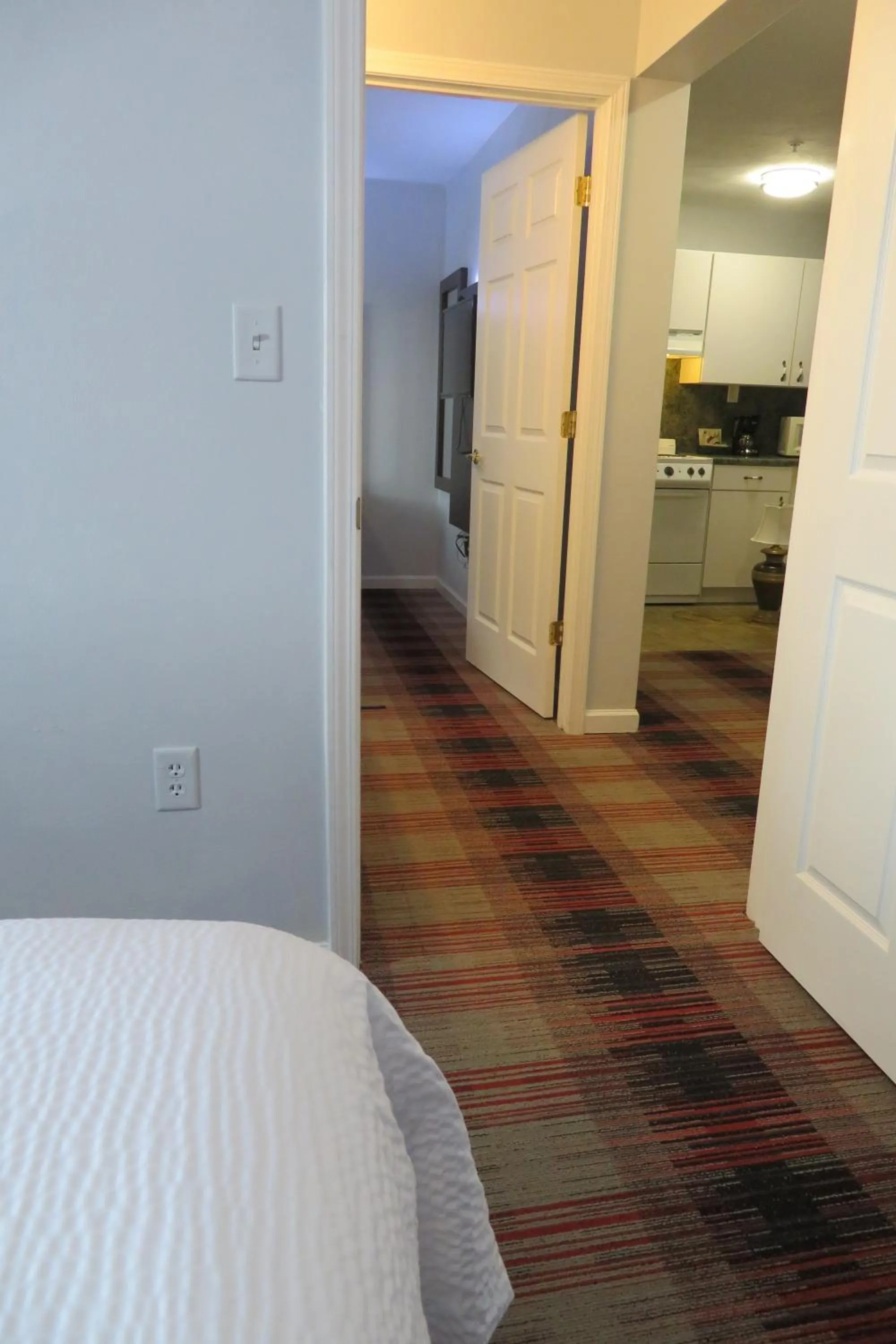 Bed in Luxbury Inn & Suites