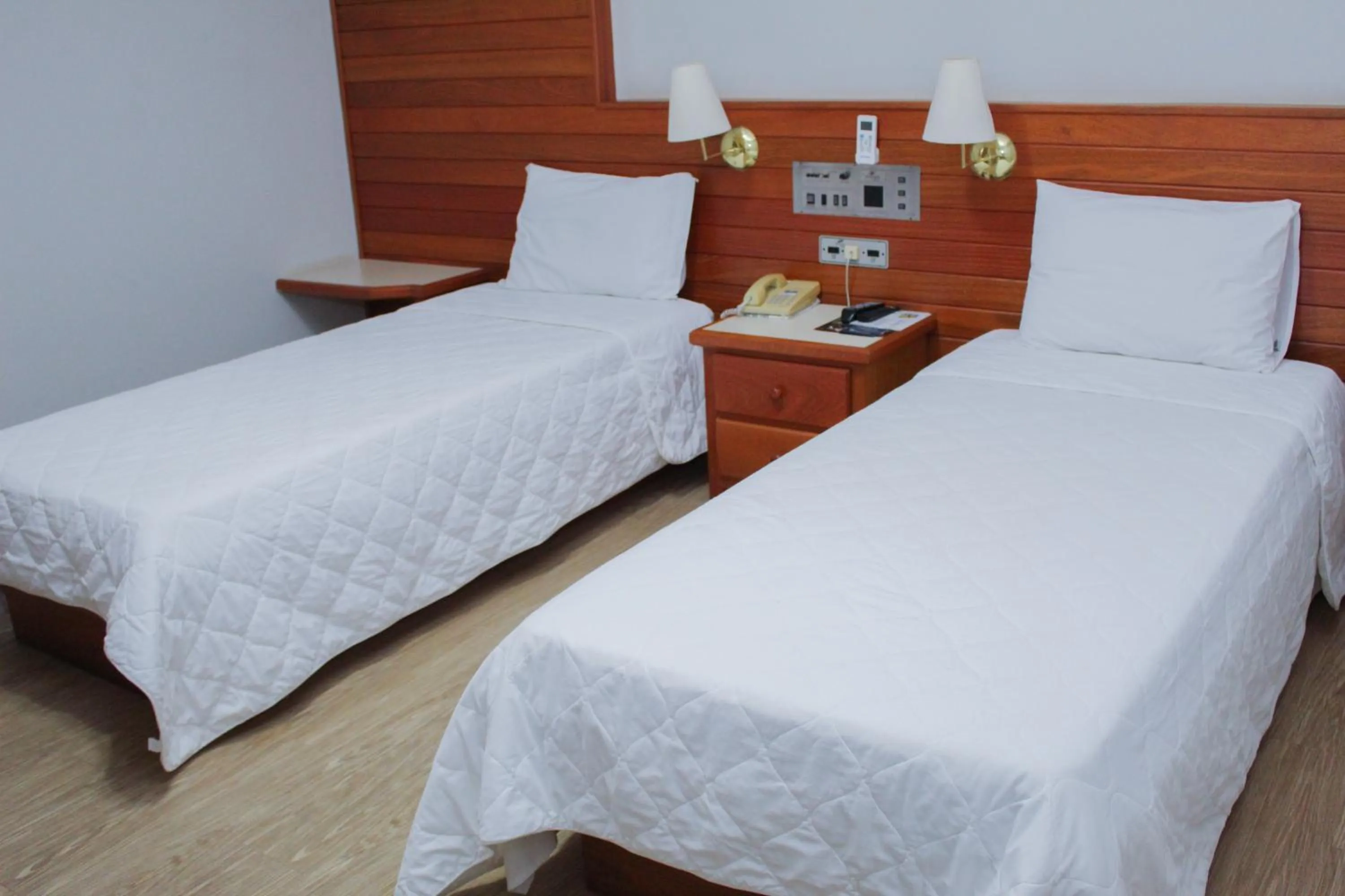 Bed in HD Plaza Hotel