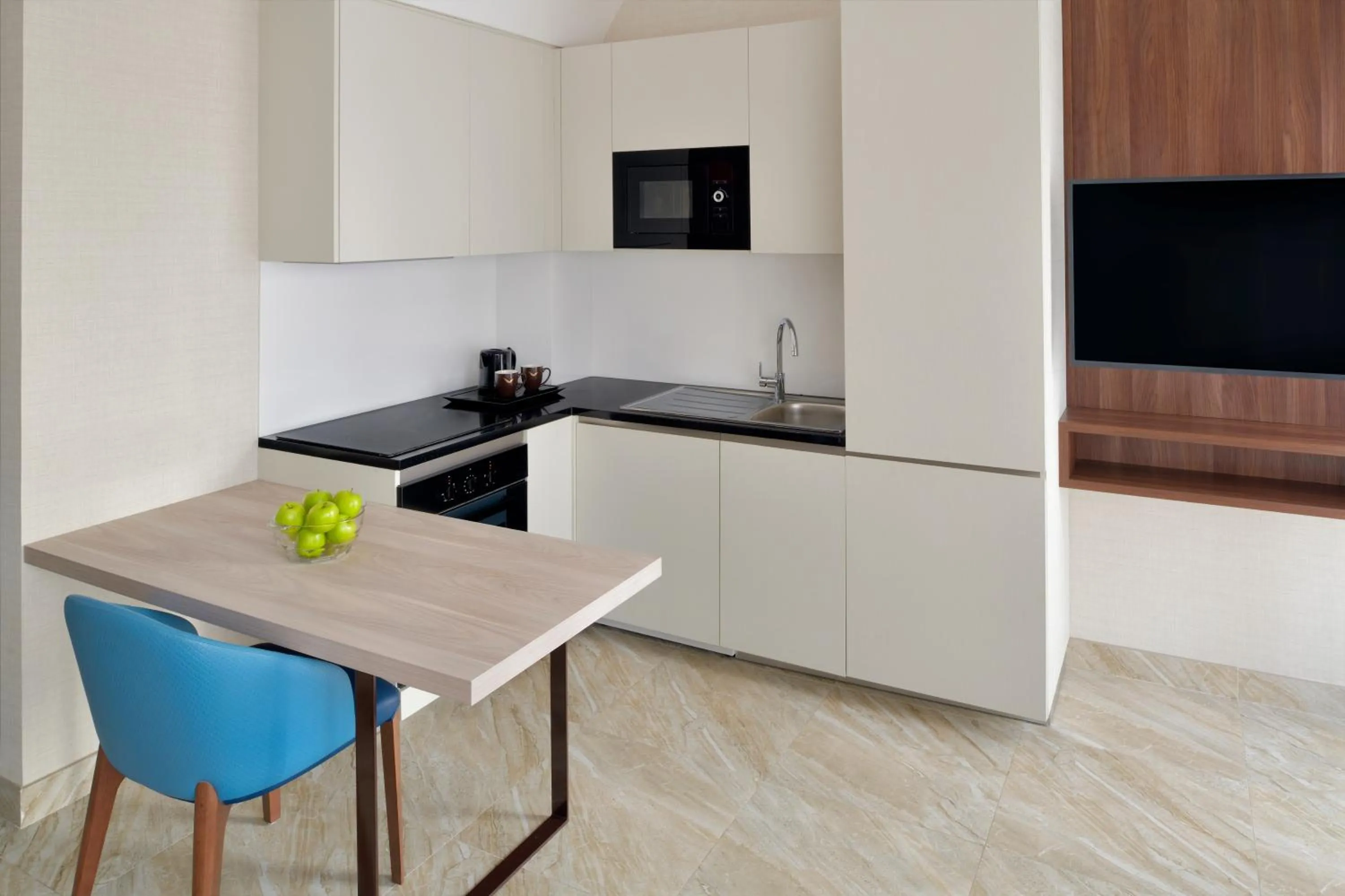 Kitchen or kitchenette in Mövenpick Hotel Apartments Downtown Dubai