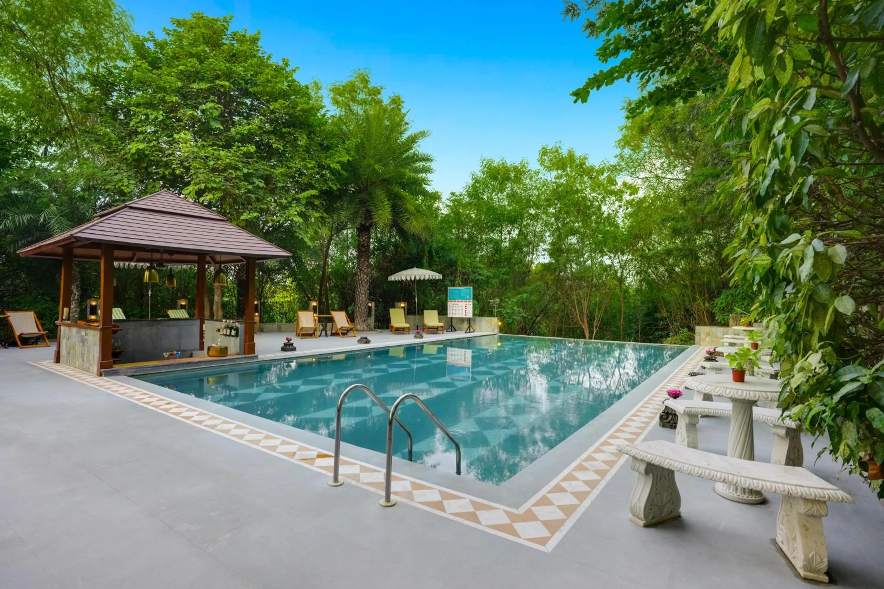 Swimming pool in The Tree House Resort, A Club Mahindra Associate