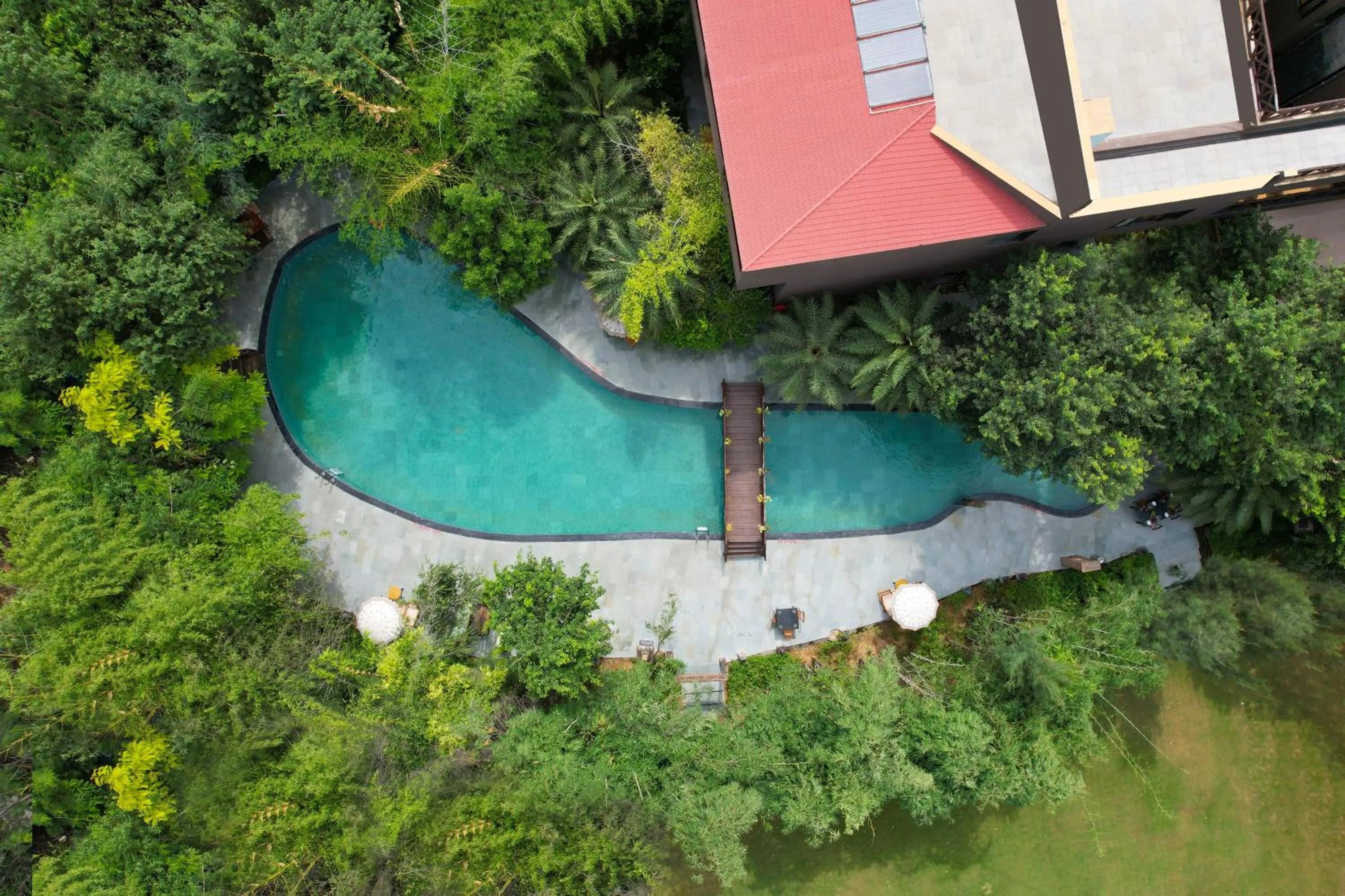 Swimming pool in The Tree House Resort, A Club Mahindra Associate