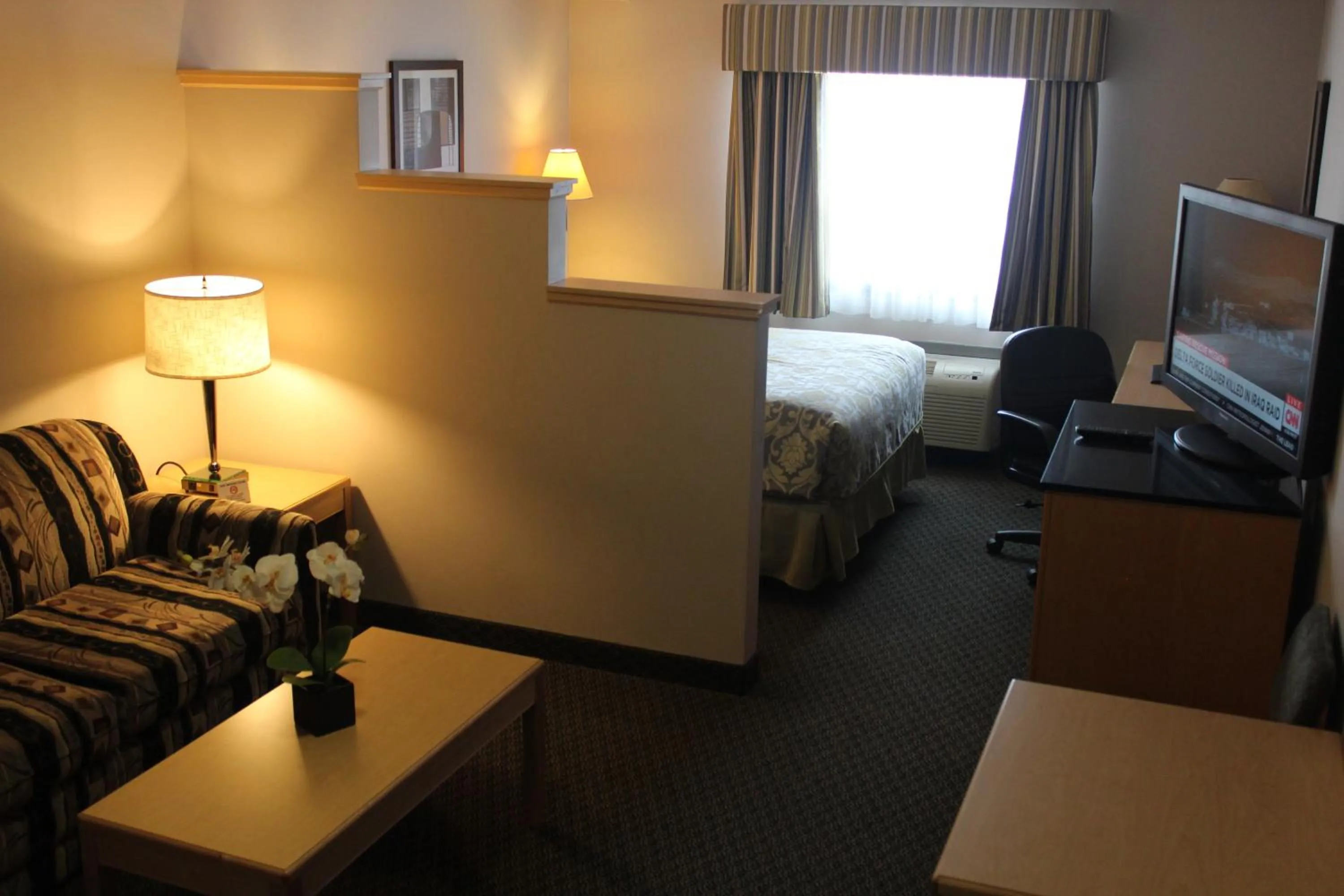 Seating area, Bed in Travelodge by Wyndham Fort McMurray
