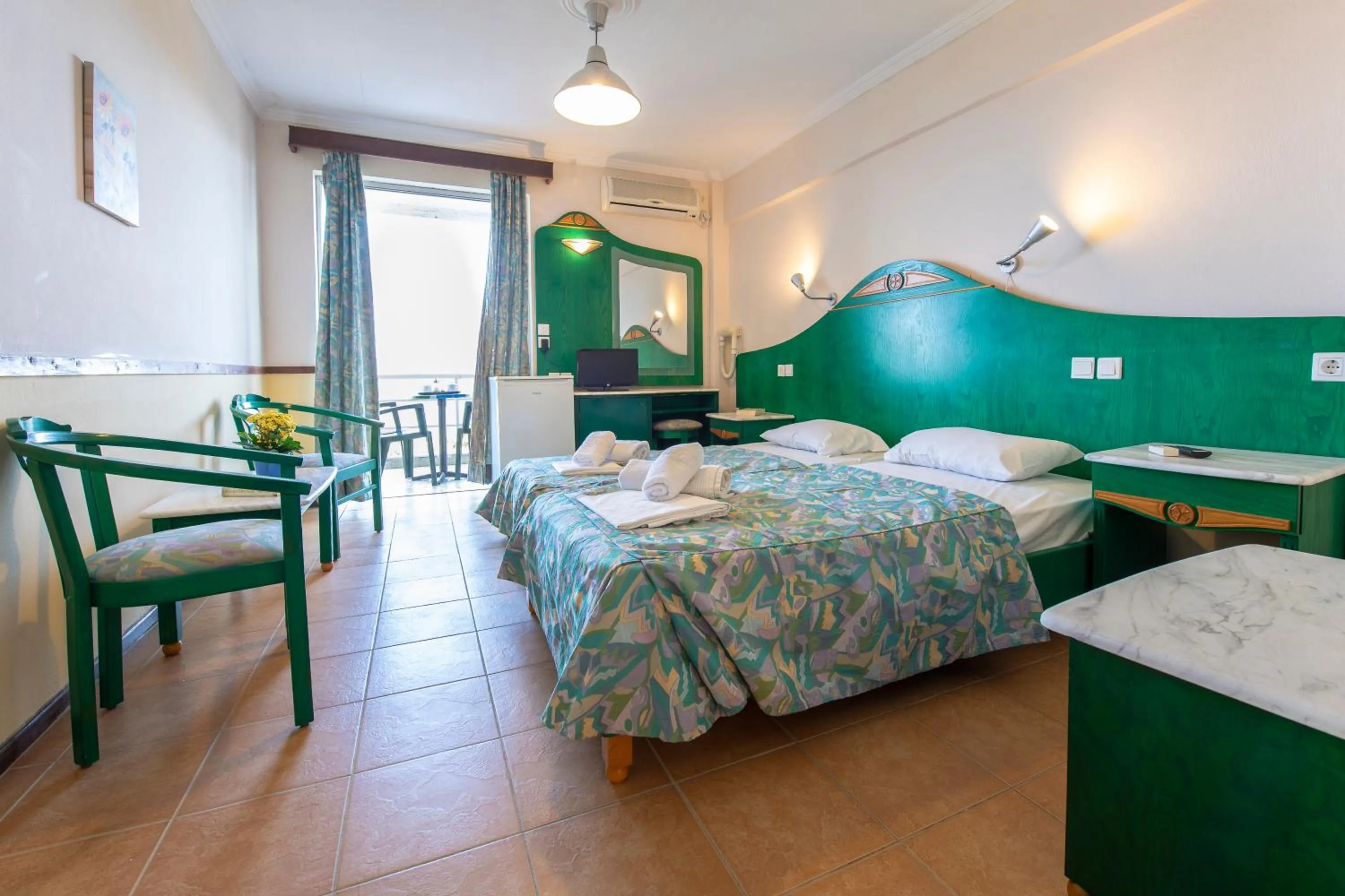 Bed in SUN HOTEL KINETA Beach Front