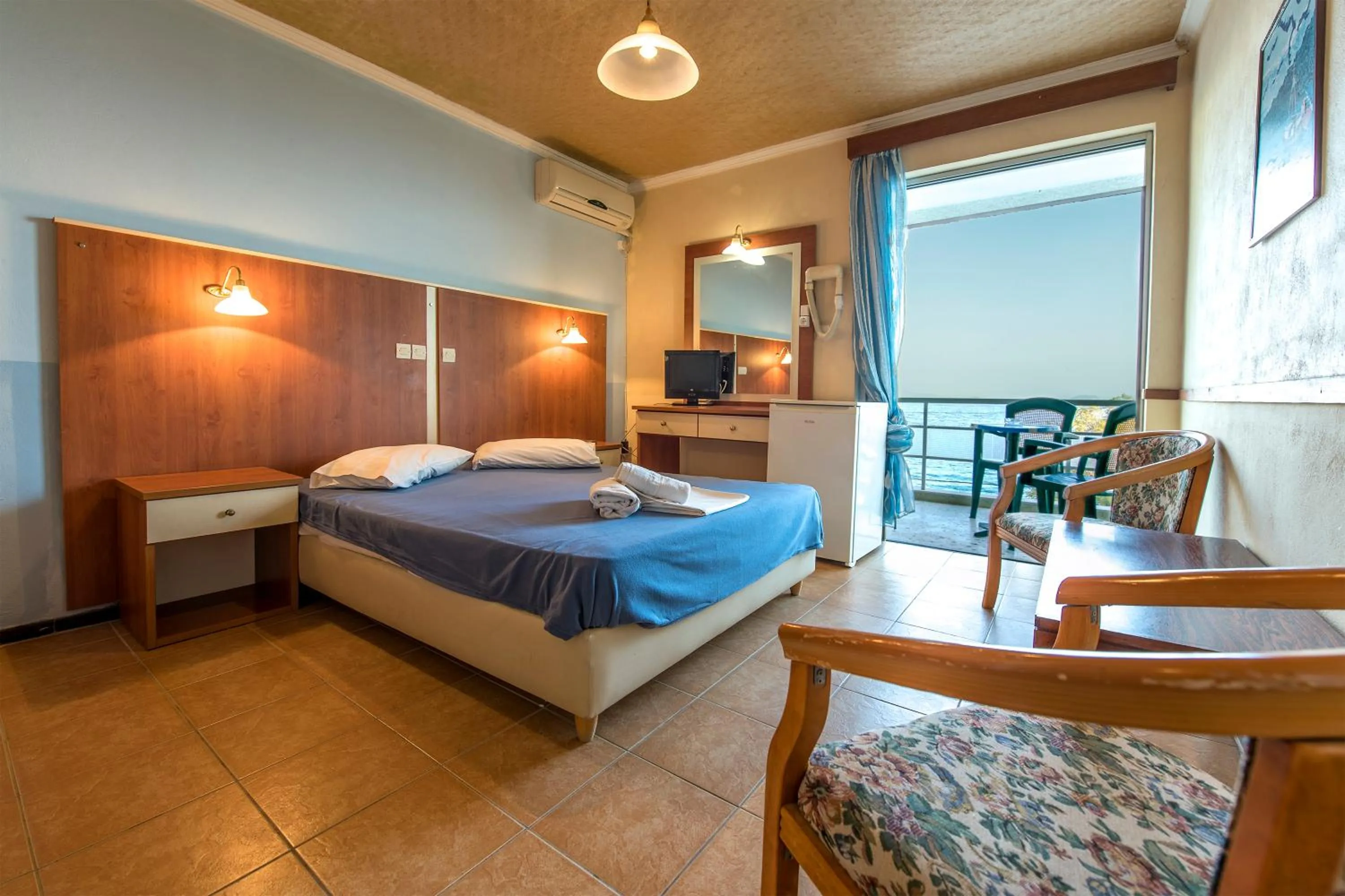 Bed in SUN HOTEL KINETA Beach Front