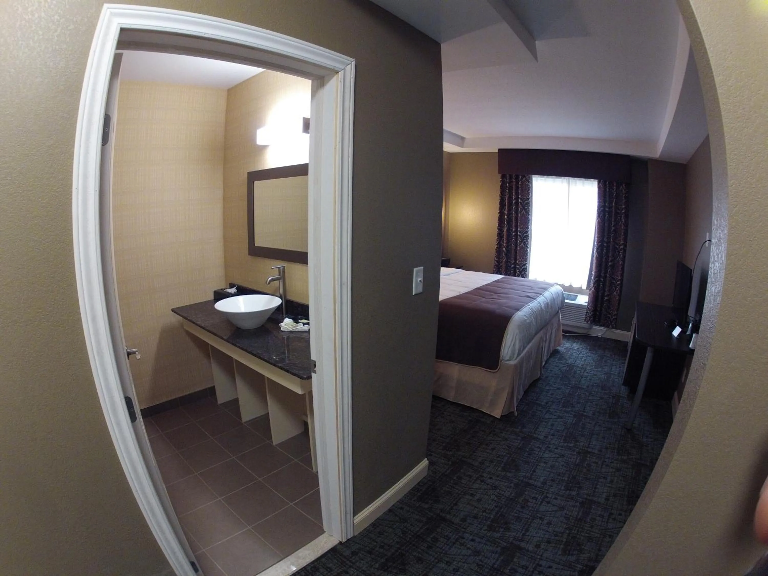 Photo of the whole room, Bed in Aashram Hotel by Niagara River