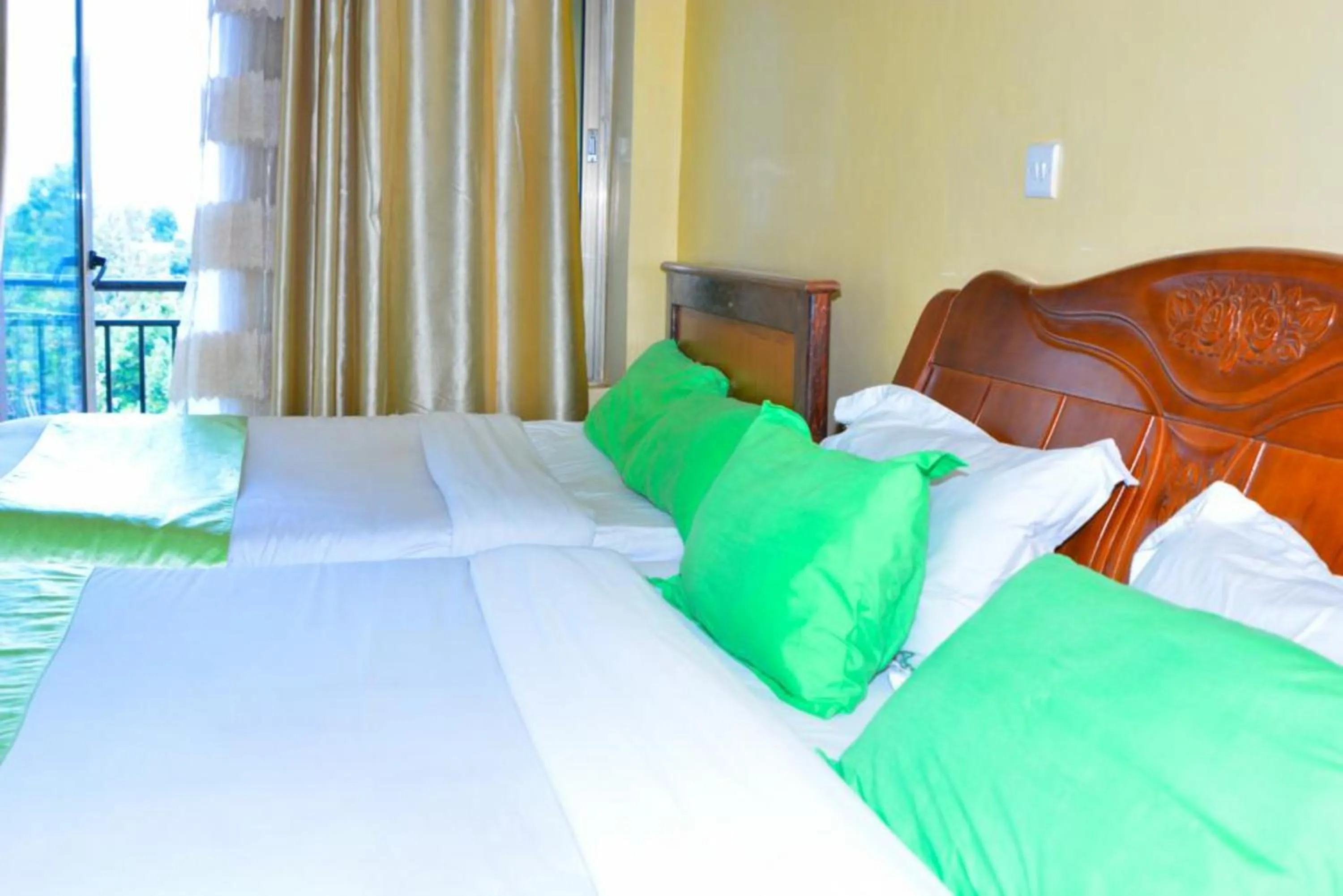 Bed in Omega Gardens Hotel