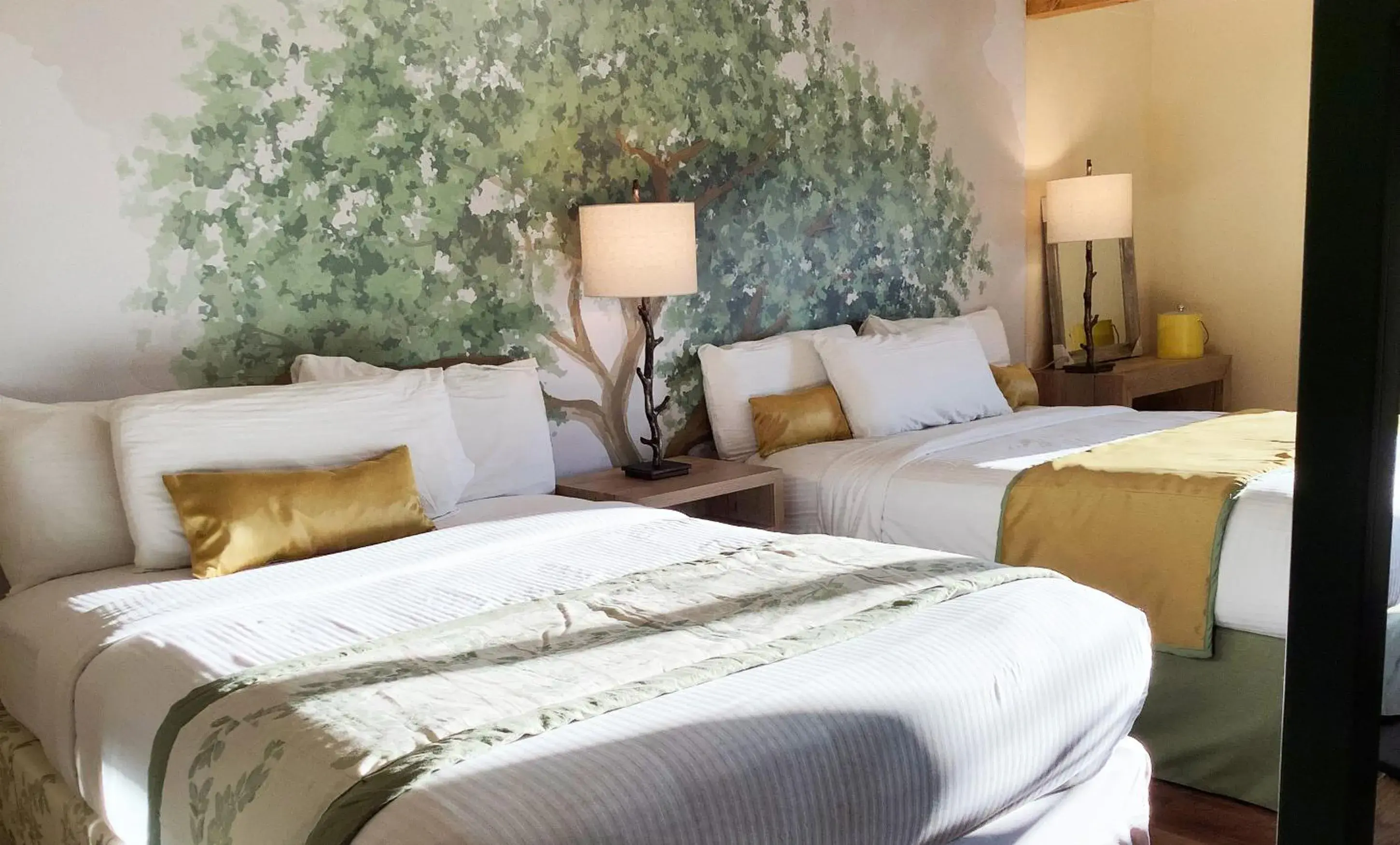 Superior Double Queen Room with Parkway View Shared Balcony with Rocking Chairs in Arbors at Island Landing Hotel & Suites Superior Double Queen Room with Parkway View Shared Balcony with Rocking Chairs in Arbors at Island Landing Hotel & Suites