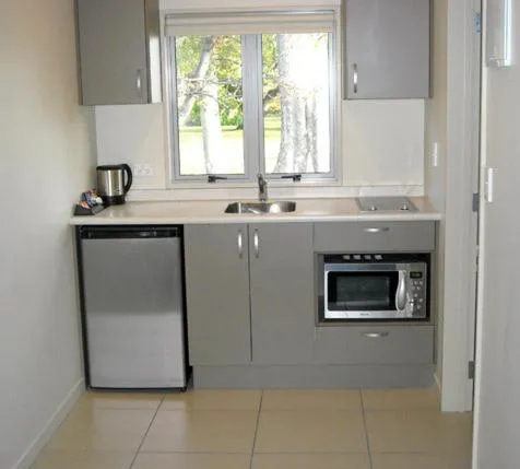 Kitchen or kitchenette in St Johns court motel