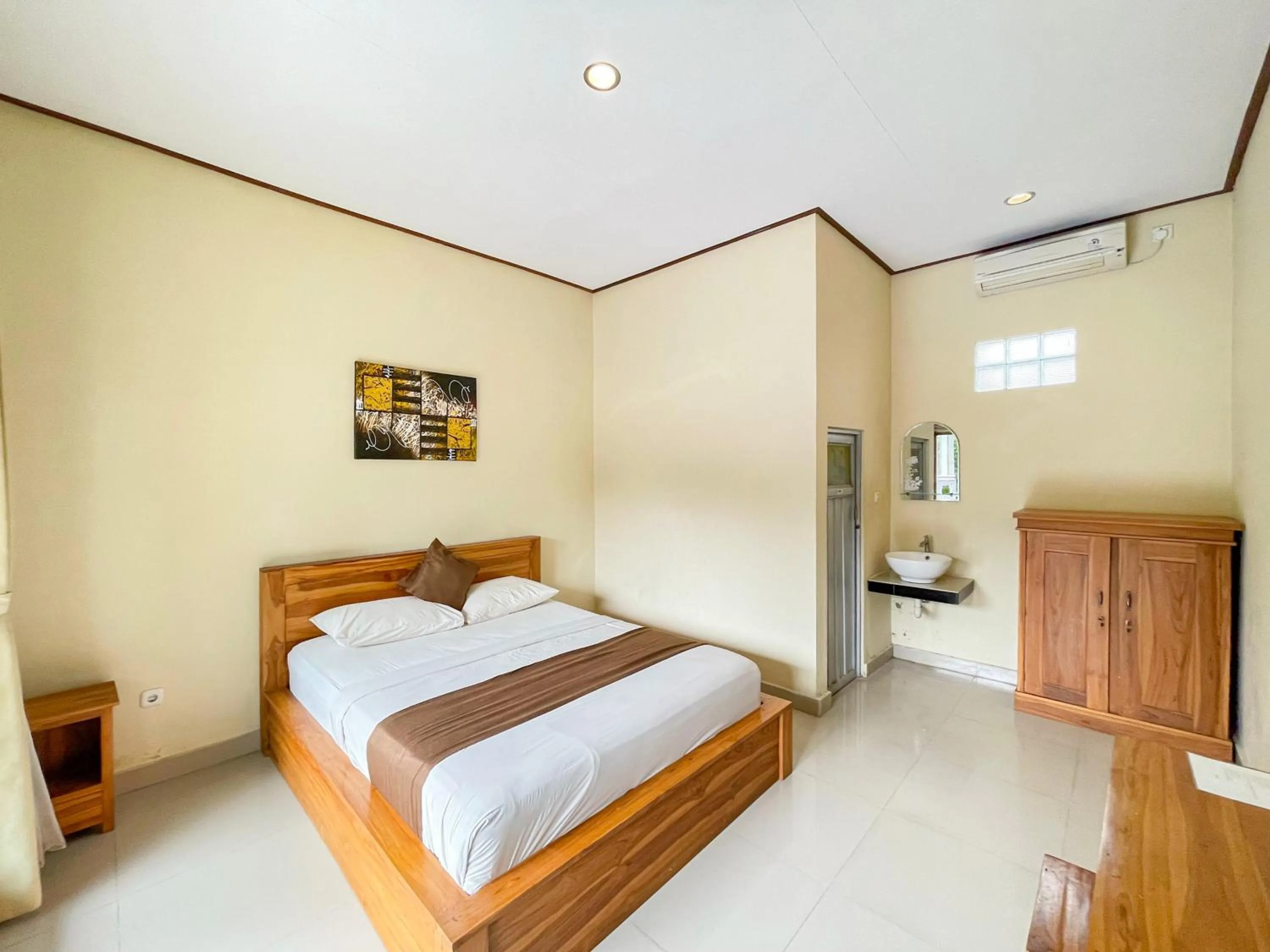 Bedroom, Bed in Urbanview Hotel Lilis Cempaka Mas Guesthouse