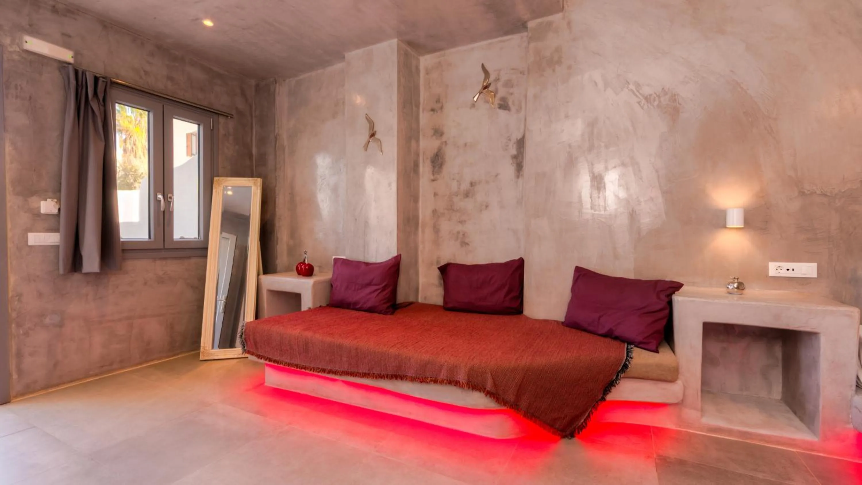 Living room, Bed in The Muses of Santorini Private Jacuzzi Suites