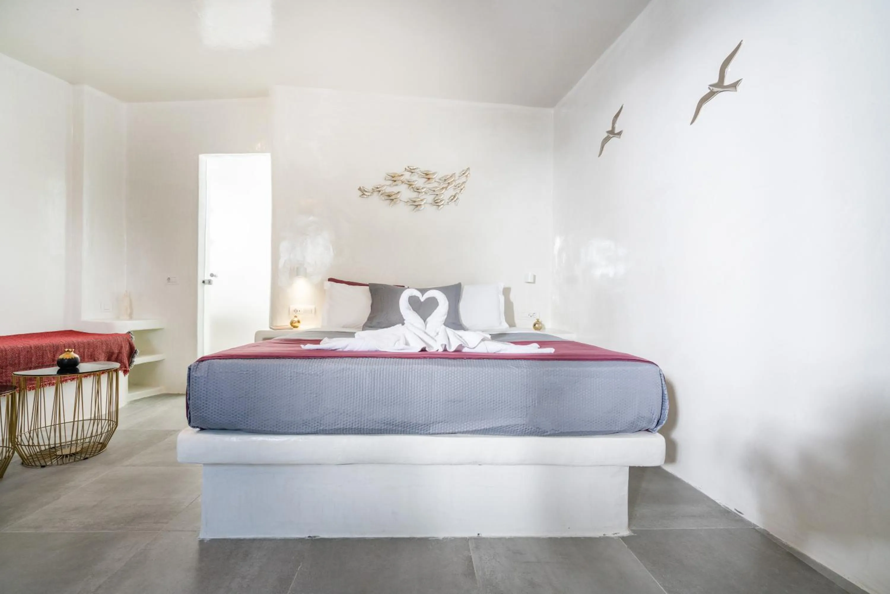 Bed in The Muses of Santorini Private Jacuzzi Suites