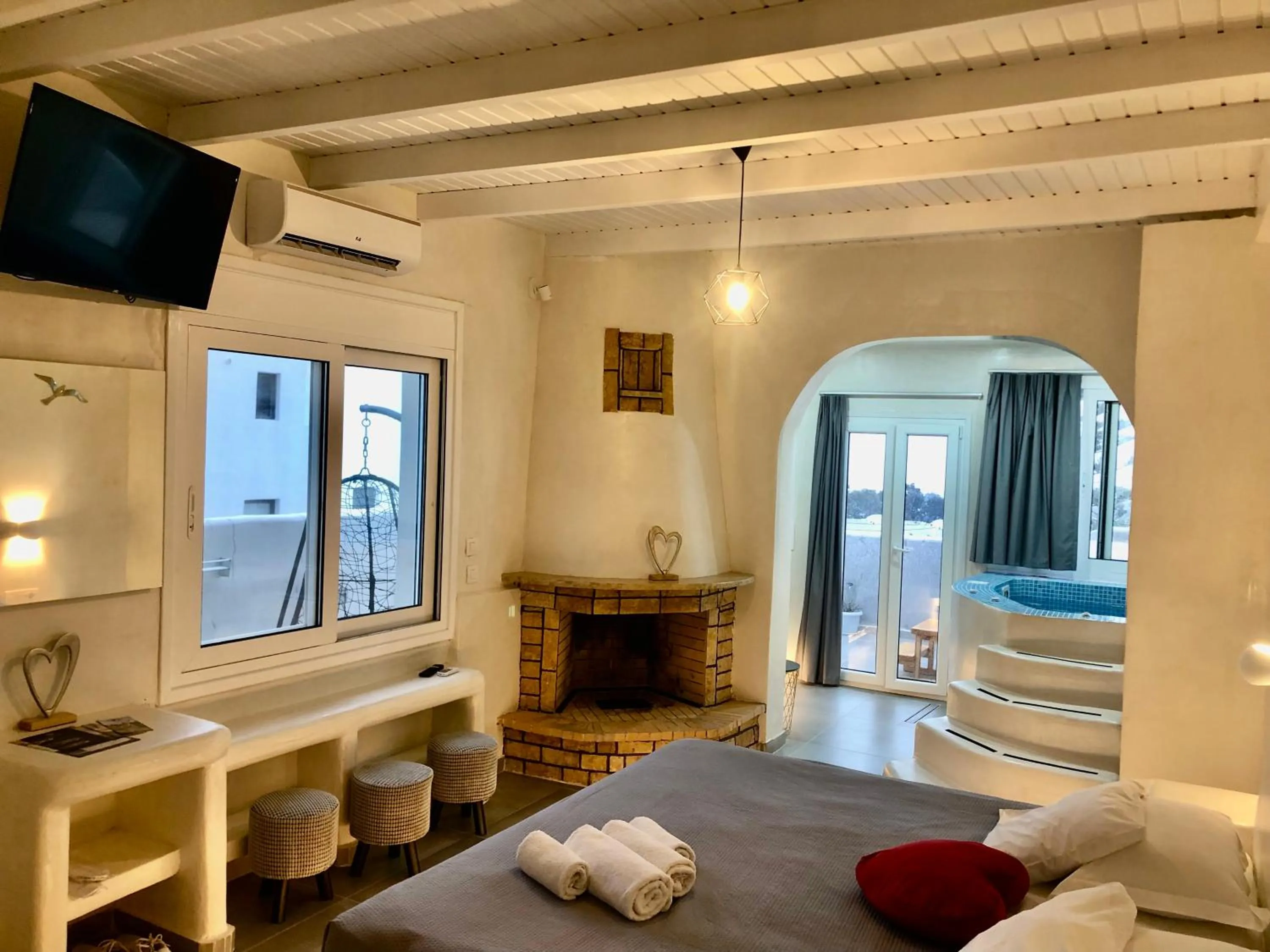 Living room, Bed in The Muses of Santorini Private Jacuzzi Suites