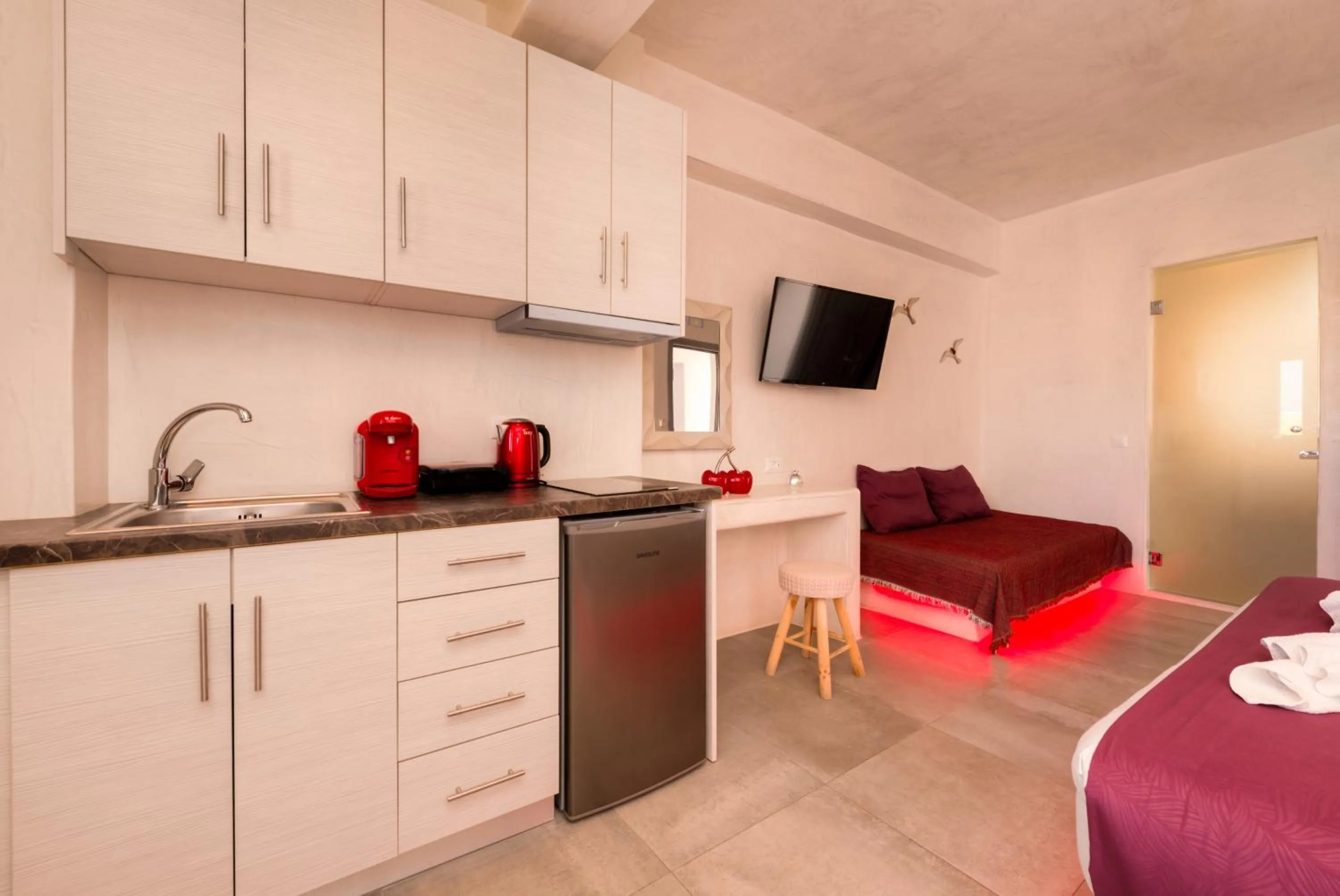 Kitchen or kitchenette, Bed in The Muses of Santorini Private Jacuzzi Suites