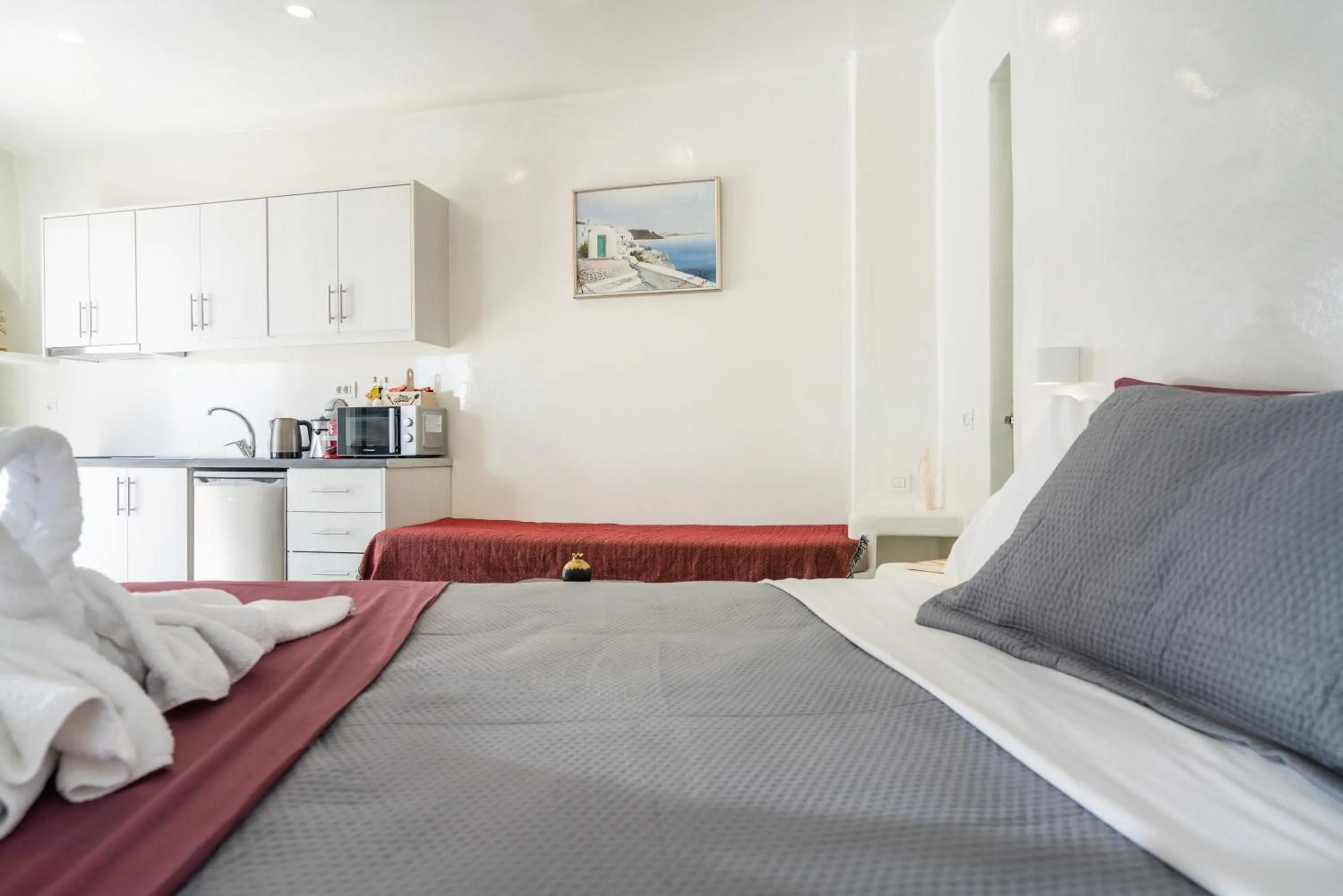 kitchen, Bed in The Muses of Santorini Private Jacuzzi Suites
